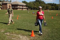 Kathia M. Purcell, wife of Master Sgt. Heriberto Purcell and native of Puerto Rico, carries two 30-pound ammunition cans while running the movement under fire portion of the combat fitness test during the 8th Engineer Support Battalion’s Jane Wayne Day, Sept. 30, 2014. By doing activities that their Marines do every day, spouses were able to gain a deeper appreciation for their husband or wife and now have a better basis for understanding and communication in their relationship. Master Sgt. Purcell is the operations chief for Company B, 8th ESB and is also a native of Puerto Rico. (Marine Corps photo by Lance Cpl. Michelle M. Reif / Released)