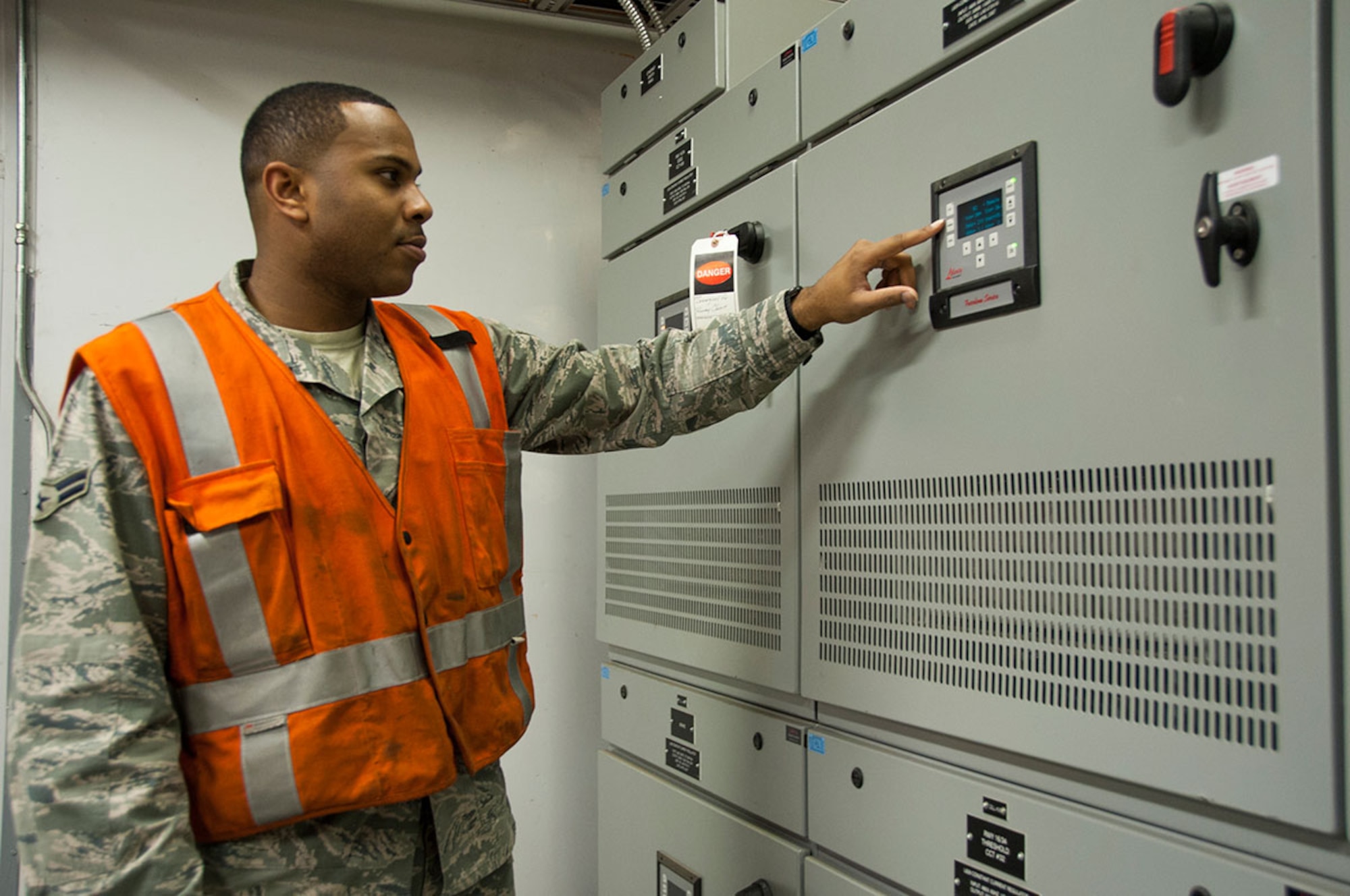 Airman 1st Class Ethen Price checks the voltage output from an enclosed high-voltage cable system Sept. 22, 2014, at Joint Base Elmendorf-Richardson, Alaska. To provide a safer work environment, the exposed 4,160 high voltage wiring has been replaced with an enclosed regulator system where the electricians can safely walk inside the vault. Price is an electrical systems journeyman with the 773rd Civil Engineer Squadron. (U.S Air Force photo/Airman 1st Class Tammie Ramsouer)