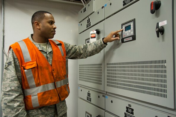 Airman 1st Class Ethen Price checks the voltage output from an enclosed high-voltage cable system Sept. 22, 2014, at Joint Base Elmendorf-Richardson, Alaska. To provide a safer work environment, the exposed 4,160 high voltage wiring has been replaced with an enclosed regulator system where the electricians can safely walk inside the vault. Price is an electrical systems journeyman with the 773rd Civil Engineer Squadron. (U.S Air Force photo/Airman 1st Class Tammie Ramsouer)
