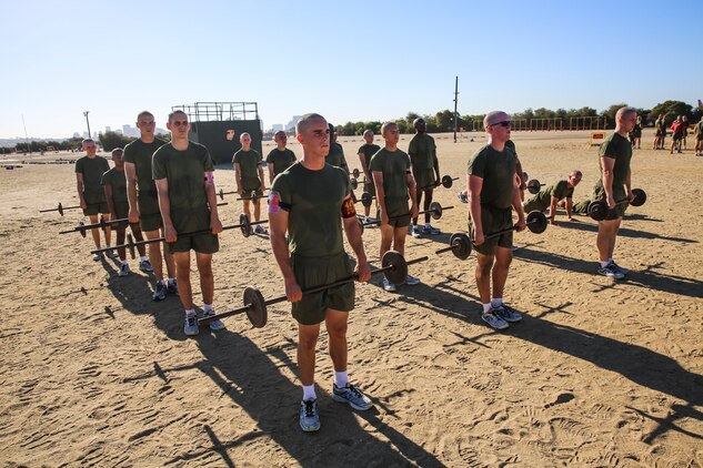 Recruits of Alpha Company, 1st Recruit Training Battalion, prepare to begin bicep curls during the circuit course event at Marine Corps Recruit Depot San Diego, Sept. 25. The Circuit Course is comprised of more than 20 exercise stations, each with its own purpose. These exercises included monkey bars, jump ropes and weight lifting. 
