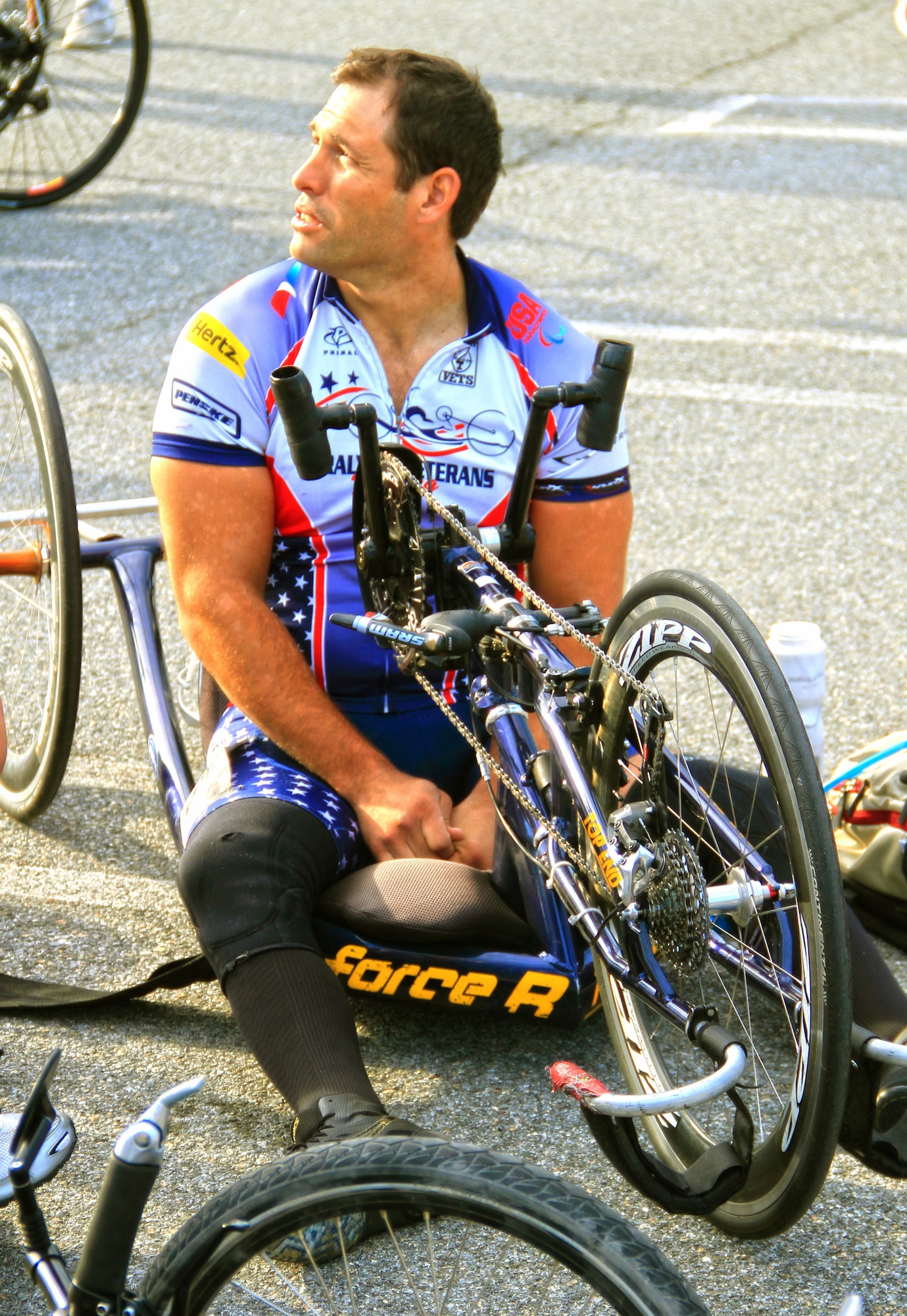 Retired Staff Sgt. Ryan Pinney adjusts the hand gears on his recumbent bike before competing in the 2014 U.S. Army Warrior Trials cycling event June 15, 2014, in West Point, N.Y. (Photo /Benny Ontiveros)