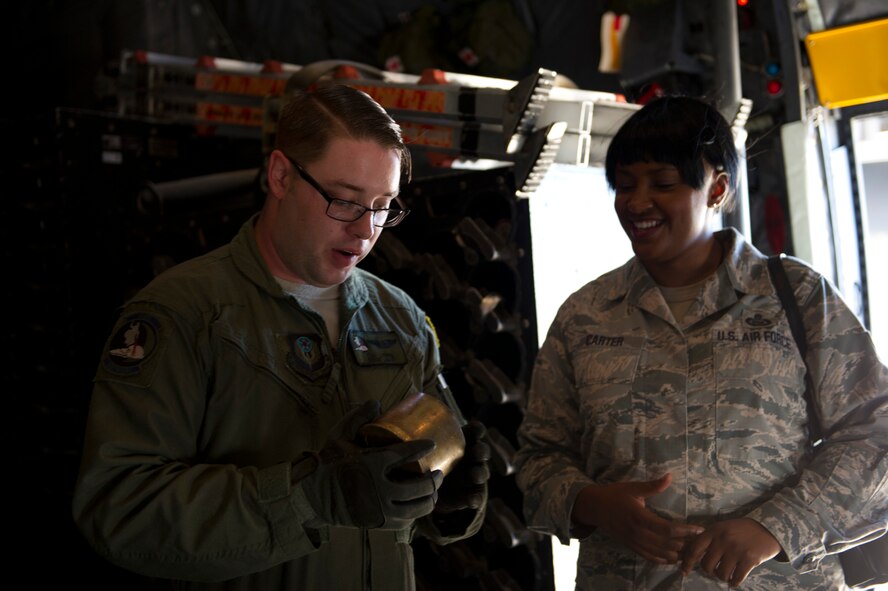 Staff Sgt. Tim Lewis, 4th Special Operations Squadron special mission’s aviator, shows Chief Maser Sgt. Michelle Carter a 105millimeter shell during a Chiefs tour at Hurlburt Field, Fla., Oct. 1, 2014. Chiefs who don’t usually interact with aircraft had the opportunity to tour the flight line and learn about its daily operations, enhancing their understanding of Hurlburt’s mission. (U.S. Air Force photo/Senior Airman Krystal M. Garrett)