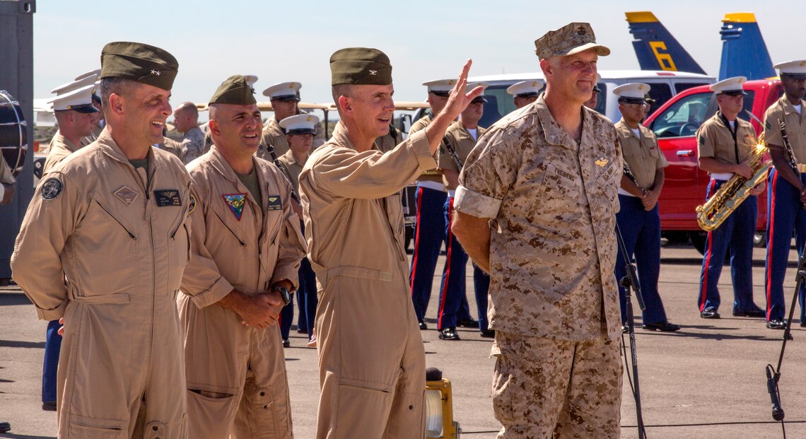 Col. John Farnam, center, Marine Corps Air Station Miramar commanding officer, waves to the audience before the opening ceremony of the 2014 Miramar Air Show aboard MCAS Miramar, Calif., Oct. 3. During the opening ceremony, the MCAS Miramar color guard raised the flag and the 3rd Marine Aircraft Wing Band performed.