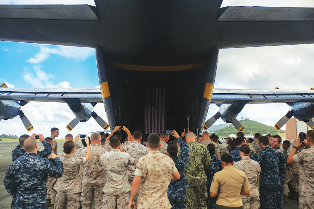MARINE CORPS AIR STATION KANEOHE BAY - Service members gather around Fat Albert, a C-130 Hercules flown by the U.S. Navy Flight Demonstration Squadron, the Blue Angels, before the scheduled training Sept. 26, 2014 at Marine Corps Air Station Kaneohe Bay. Service members were given an opportunity to ride aboard the aircraft while the Blue Angels were training there. (U.S. Marine Corps photo by Pfc. Harley Thomas)