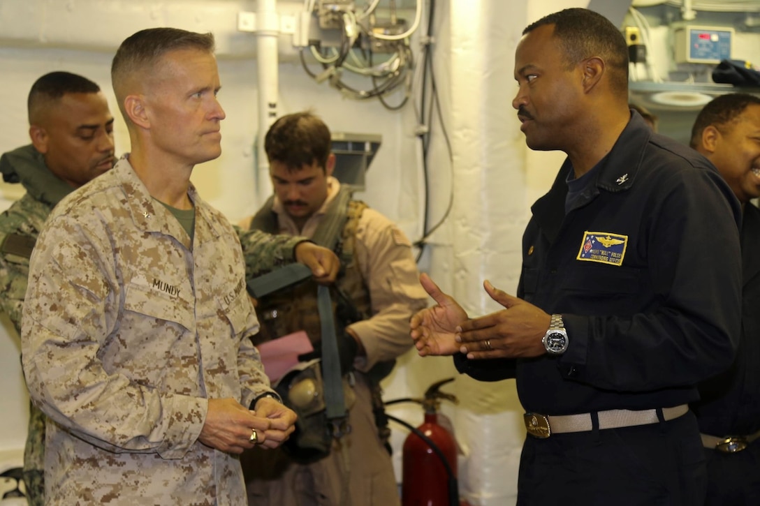Brig. Gen. Carl Mundy, commander, Combined Task Force 51, speaks with Capt. Alvin Holsey, commanding officer, USS Makin Island before departing the Makin Island, Sept. 29.  Mundy visited the Marines and sailors deployed with the Makin Island Amphibious Ready Group (ARG) and the embarked 11th Marine Expeditionary Unit (MEU) in support of maritime security operations and theater security cooperation efforts in the U.S. 5th Fleet area of responsibility.  (U.S. Marine Corps photo by Cpl. Laura Y. Raga/ RELEASED)