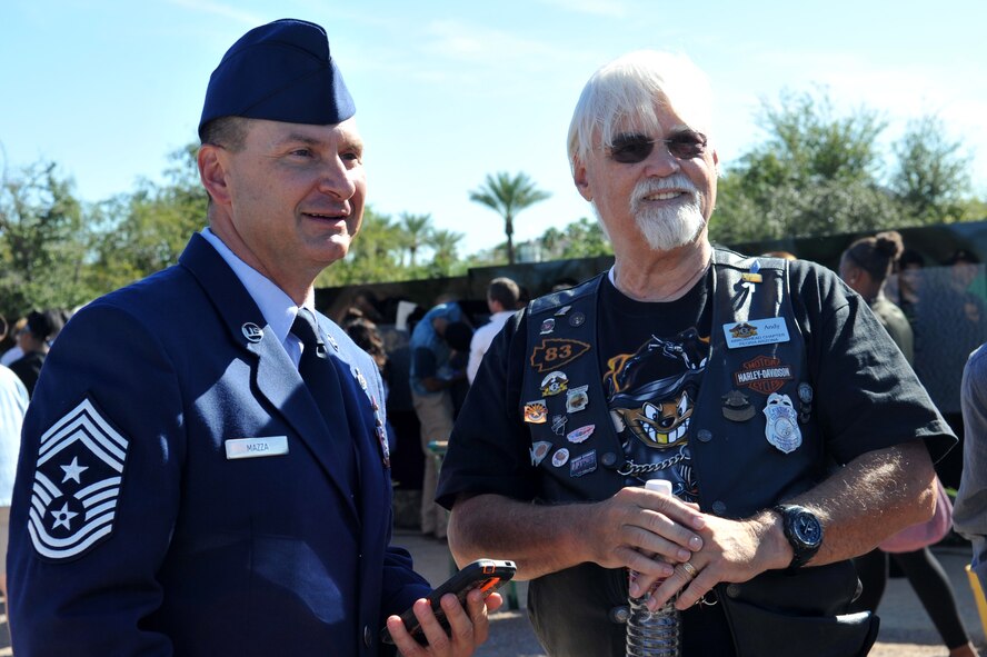Chief Master Sgt. John Mazza, 56th Fighter Wing command chief, greets Vietnam Veteran Andy LaCour, following the opening ceremony of the The Moving Wall Vietnam Memorial in Goodyear, Arizona, Oct. 3, 2014. The wall is a half-sized replica of the Vietnam Memorial in Washington D.C., and honors the more than 58,000 Vietnam Veterans who gave their lives or remain missing in action. (U.S. Air Force Photo by Senior Airman Jenna Sarvinski) 