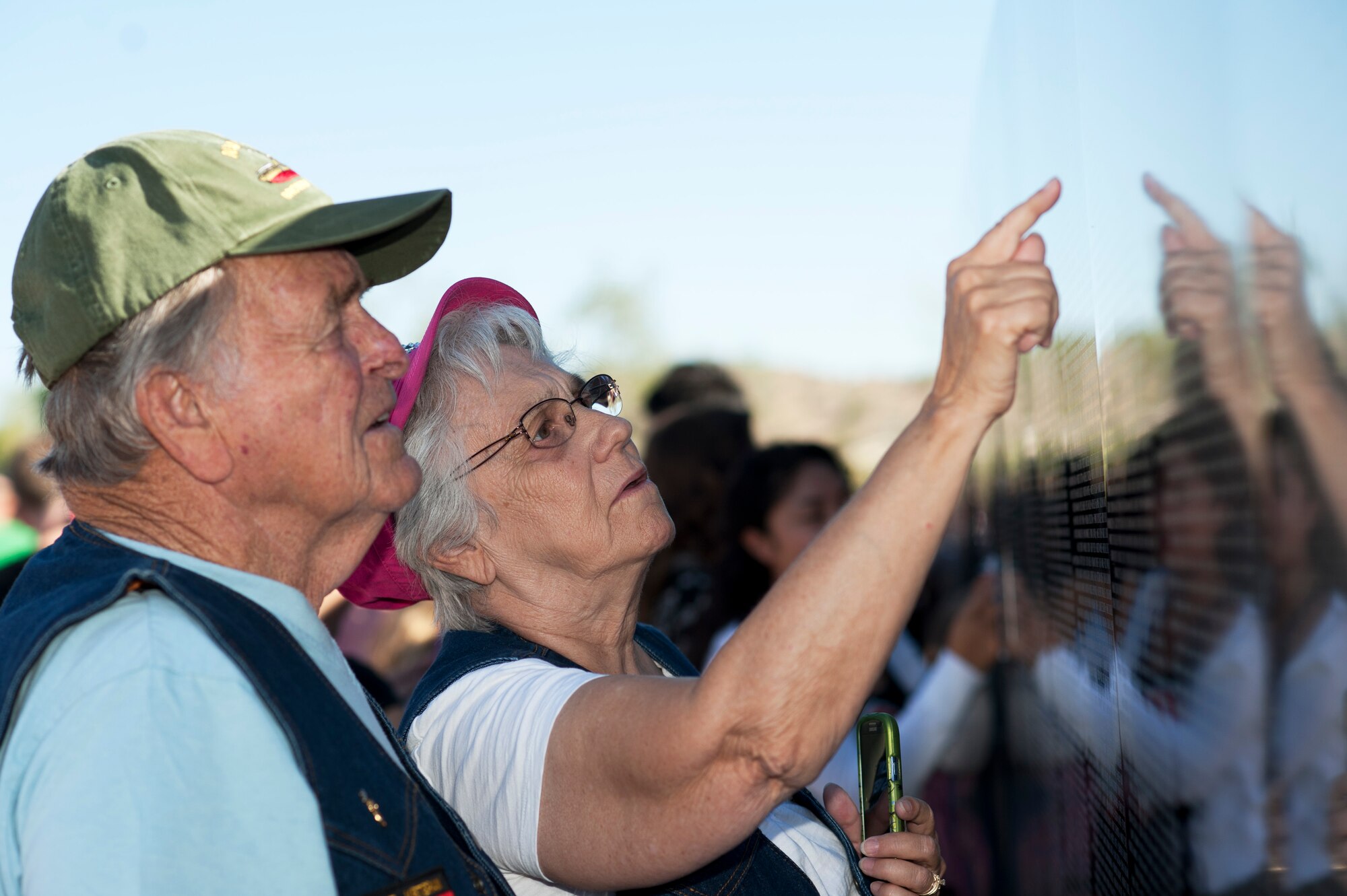 Ed Doughty, U.S. Navy Vietnam veteran, and his wife, Irene, search for names on "The Moving Wall," a Vietnam veterans memorial wall, in Goodyear, Arizona, Oct. 03, 2014. Inscribed on the black granite walls are the names of more than 58,249 men and women who gave their lives or remain missing. (U.S. Air Force photo by Staff Sgt. Staci Miller) 