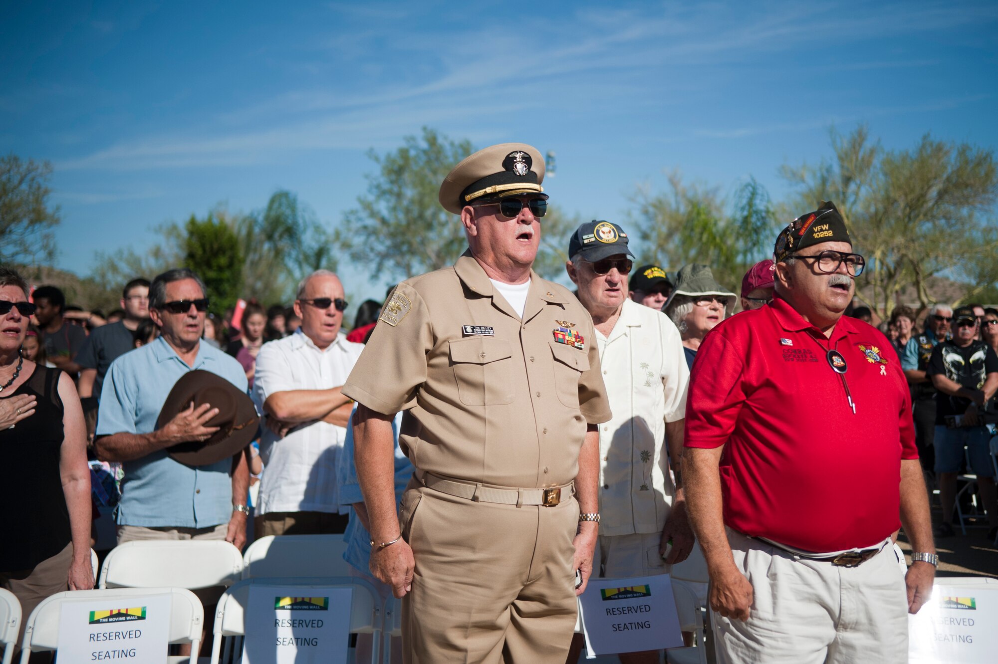 A crowd of more than 500 people, including active military and veterans sing "God Bless America" during the opening ceremony of "The Moving Wall," a Vietnam veterans memorial wall, in Goodyear, Arizona, Oct. 03, 2014. Inscribed on the black granite walls are the names of more than 58,249 men and women who gave their lives or remain missing. (U.S. Air Force photo by Staff Sgt. Staci Miller) 