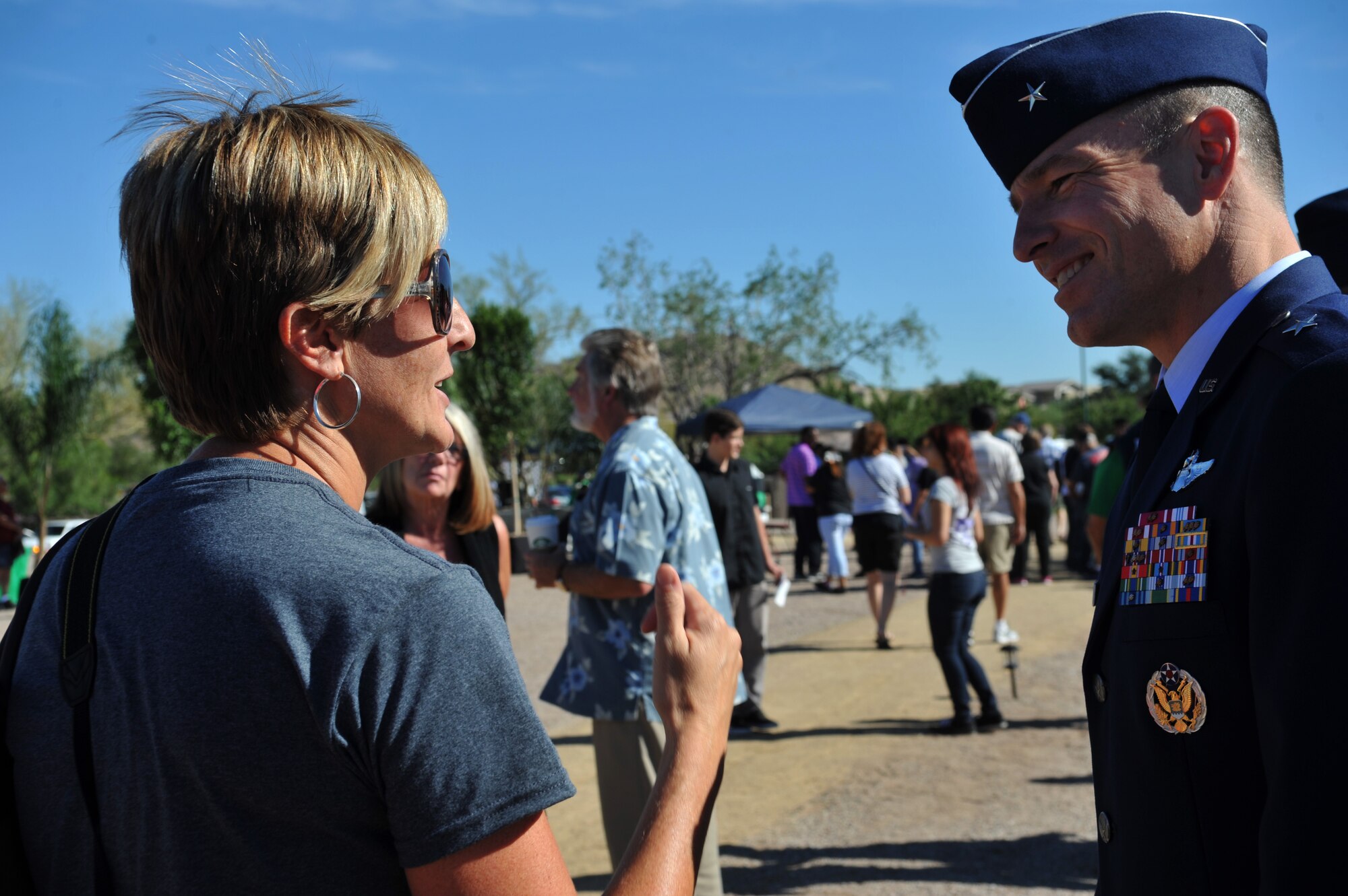 Brig. Gen. Scott Pleus, 56th Fighter Wing commander, greets a member of the community following the opening ceremony of the The Moving Wall Vietnam Memorial in Goodyear, Arizona, Oct. 3, 2014.  The wall is a half-sized replica of the Vietnam Memorial in Washington D.C., and honors the more than 58,000 Vietnam Veterans who gave their lives or remain missing in action. (U.S. Air Force Photo by Senior Airman Jenna Sarvinski) 