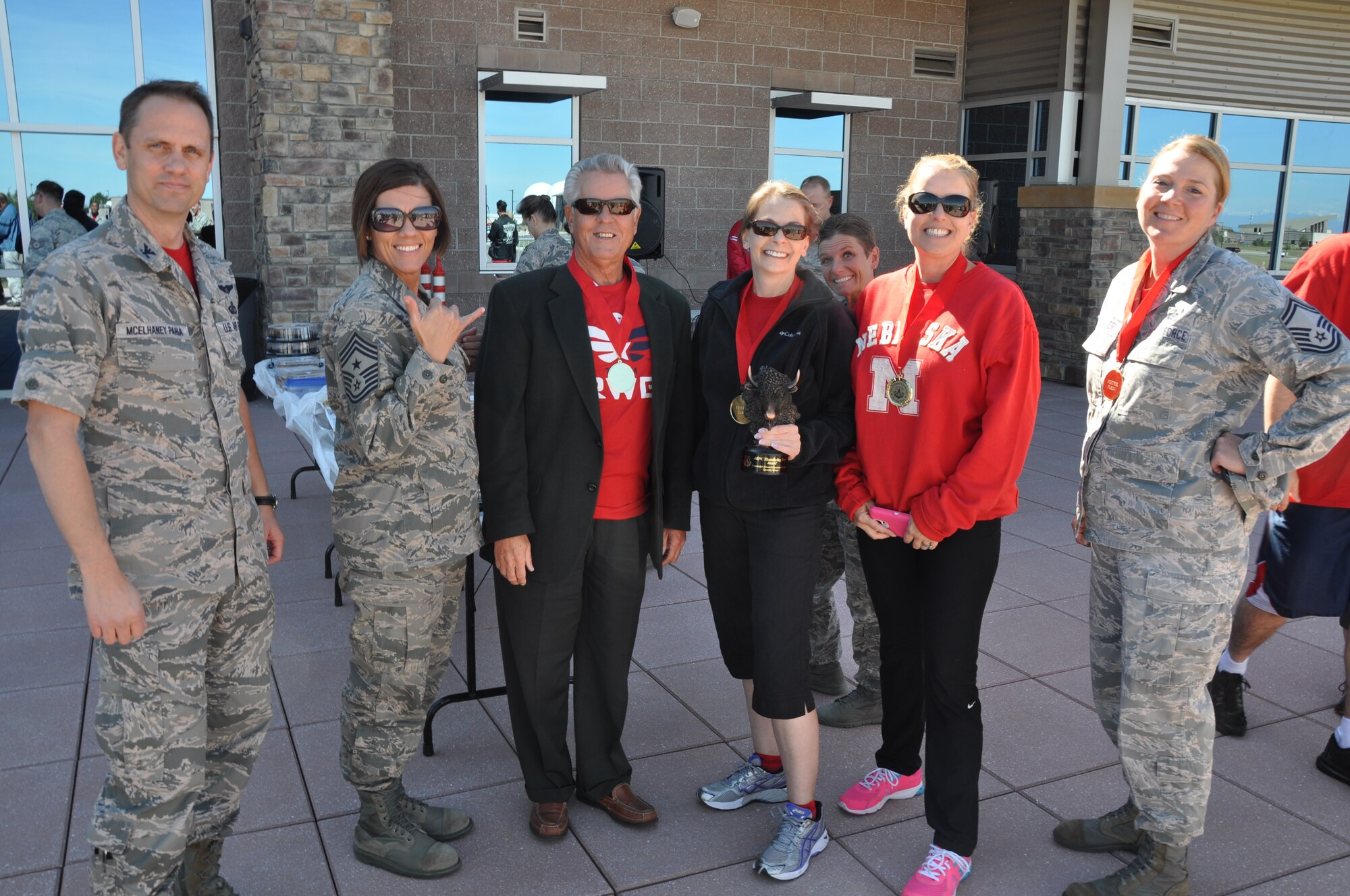 Col. Sean McElhaney Pahia, Air Reserve Personnel Center vice commander, and Chief Master Sgt. Ruthe Flores, ARPC command chief, present the "The Ten-acious Herd" team a medal and the ARPC Thundering Herd award during ARPC's Commander's Fitness Enhancement Program quarterly fitfest Oct. 3, 2014, on Buckley Air Force Base, Colo. (U.S. Air Force photo/Tech. Sgt. Rob Hazelett) 