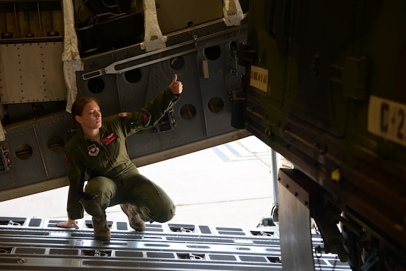 ALTUS AIR FORCE BASE, Okla. – U.S. Air Force Staff Sgt. Laura Bourdlais, 58th Airlift Squadron instructor loadmaster, assists a driver as his vehicle backs into place aboard a U.S. Air Force C-17 Globemaster III cargo aircraft during joint mission training, Oct. 2, 2014. U.S. Army Soldiers from the 4th Battalion, 3rd Air Defense Artillery Regiment, 31st Air Defense Artillery Brigade, Fort Sill, Okla., had the opportunity to practice rapid deployment with 15 pieces of equipment. (U.S. Air Force photo by Airman 1st Class Megan E. Acs/Released)