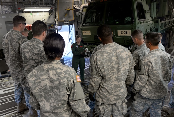 ALTUS AIR FORCE BASE, Okla. – U.S. Air Force Staff Sgt. Laura Bourdlais, 58th Airlift Squadron instructor loadmaster, instructs a group of U.S. Army Soldiers from the 4th Battalion, 3rd Air Defense Artillery Regiment, 31st Air Defense Artillery Brigade, Fort Sill, Okla., on how to secure a vehicle once loaded into a U.S. Air Force C-17 Globemaster III cargo aircraft Oct. 2, 2014. This was the first time many of the Soldiers had been inside a C-17 for training. (U.S. Air Force photo by Airman 1st Class Megan E. Acs/Released)