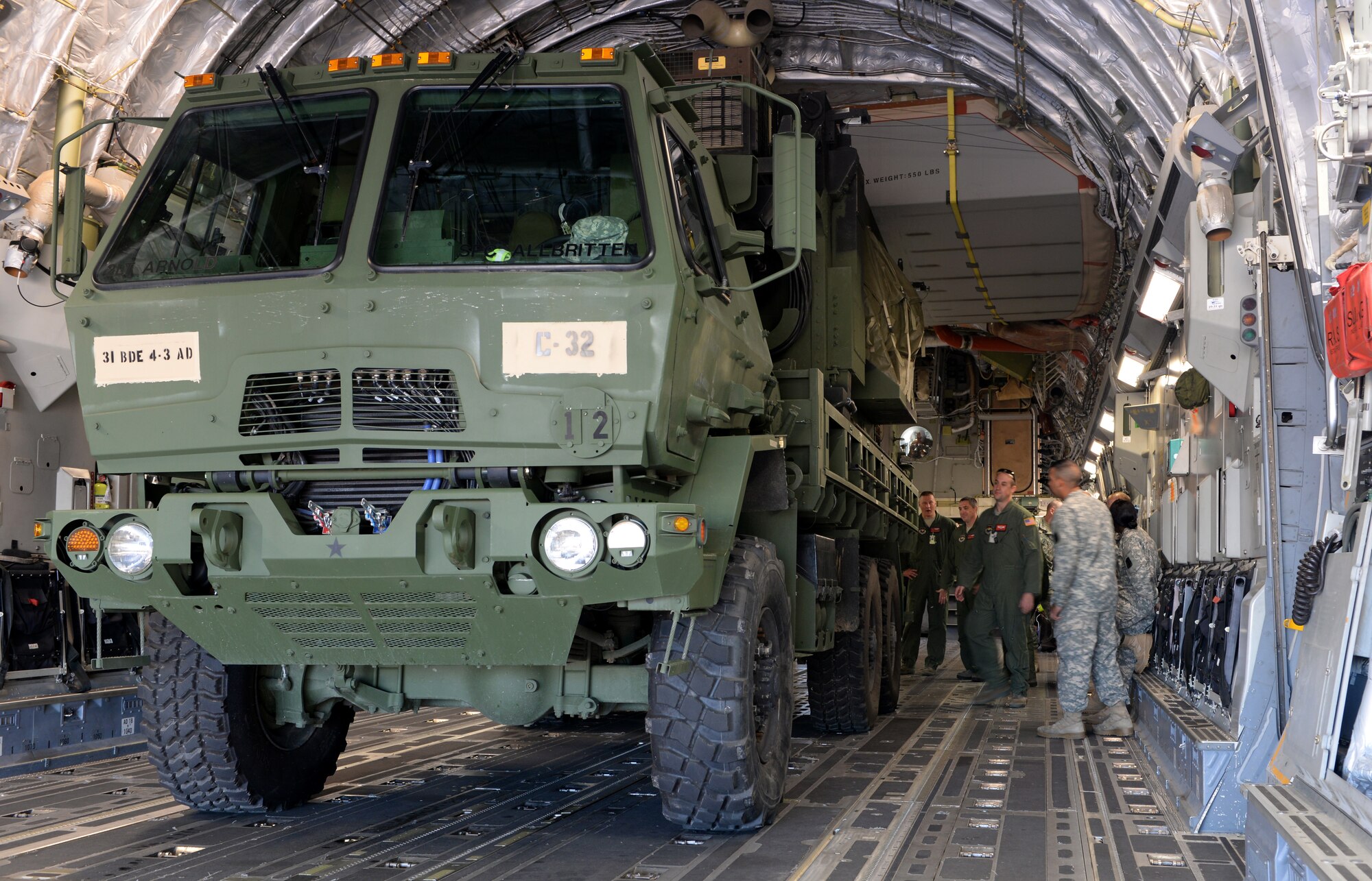 ALTUS AIR FORCE BASE, Okla. – U.S. Air Force Airmen and U.S. Army Soldiers gather around a vehicle inside a U.S. Air Force C-17 Globemaster III cargo aircraft during a joint training mission, Oct. 2, 2014. Approximately 100 Soldiers from 4th Battalion, 3rd Air Defense Artillery Regiment, 31st Air Defense Artillery Brigade, Fort Sill, Okla., practiced loading and unloading the aircraft with 15 pieces of equipment. (U.S. Air Force photo by Airman 1st Class Megan E. Acs/Released)