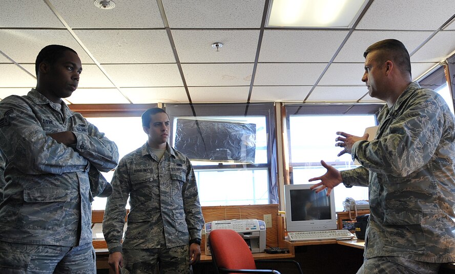 Senior Airman Xavier Love (left), 319th Communications Squadron cyber transport technician, and Airman Juan Robalino (center), 319th Logistics Readiness Squadron equipment accountability apprentice, listen to Lt. Col. Jefferey Becker, 319th Security Forces commander, as he explains what the security teams at the Oscar-Zero Missile Alert Facility were responsible for in Cooperstown, N.D., Sept. 26, 2014. Becker managed five different missile alert facility security teams while stationed at Minot Air Force Base, N.D., from 1999-2001, one of them being the Oscar-Zero MAF. Becker and the junior enlisted Airmen are assigned to Grand Forks Air Force Base, N.D. (U.S. Air Force photo/Airman 1st Class Bonnie Grantham)