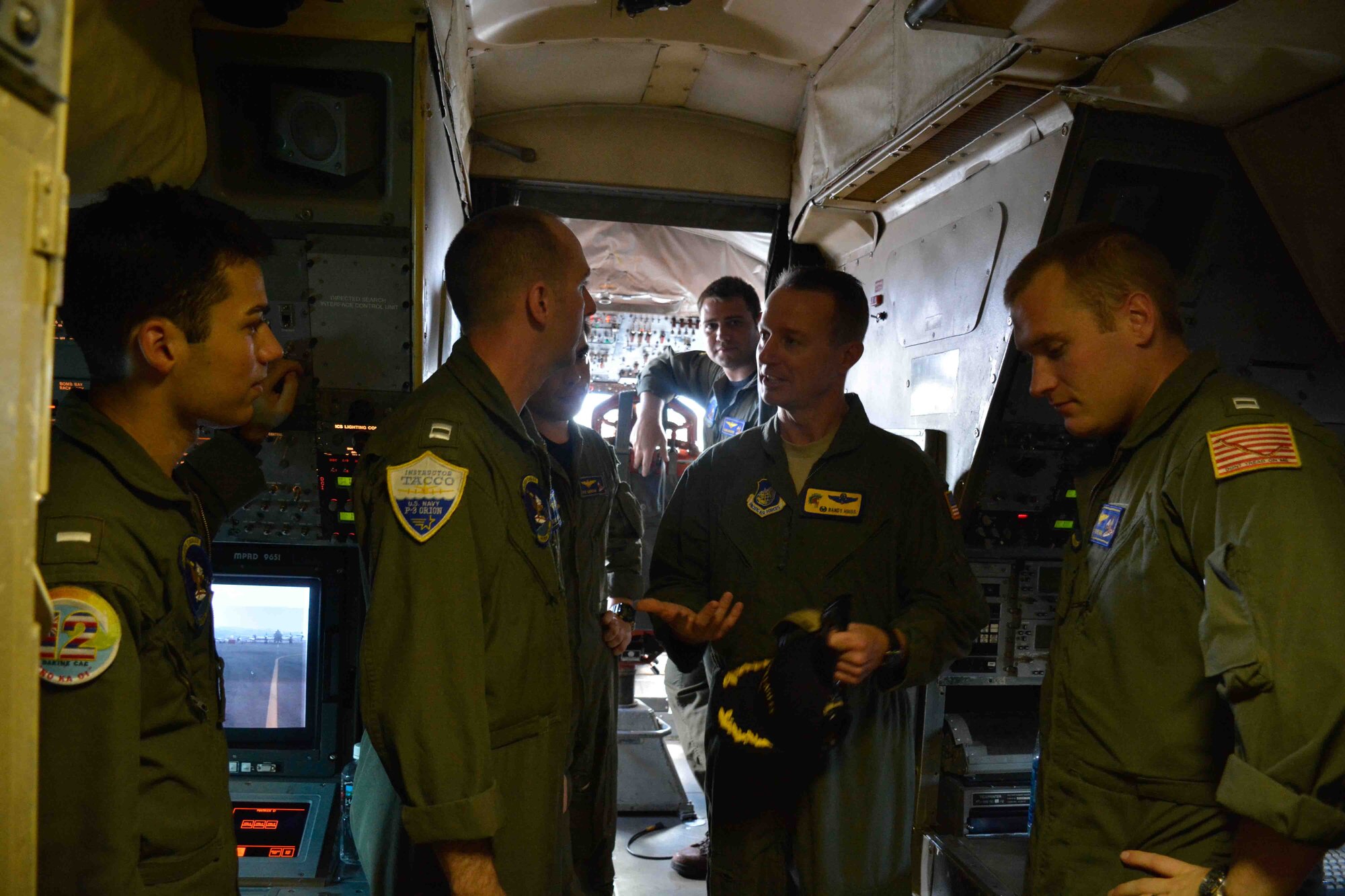 Col. Randy Huiss, 15th Wing commander, talks to Sailors assigned to the ‘Golden Eagles’ of Patrol Squadron (VP) 9, during a tour of the squadron’s P-3C Orion maritime patrol aircraft at Joint Base Pearl Harbor Hickam Hawaii. VP-9 will be operating out of Hickam Airfield during a two-month renovation of Marine Corps Base Hawaii spaces, requiring coordination and cooperation between Navy and Air Force commands to ensure successful missions. (U.S. Navy photo by Mass Communication Specialist 3rd Class Amber L. Porter/Released)