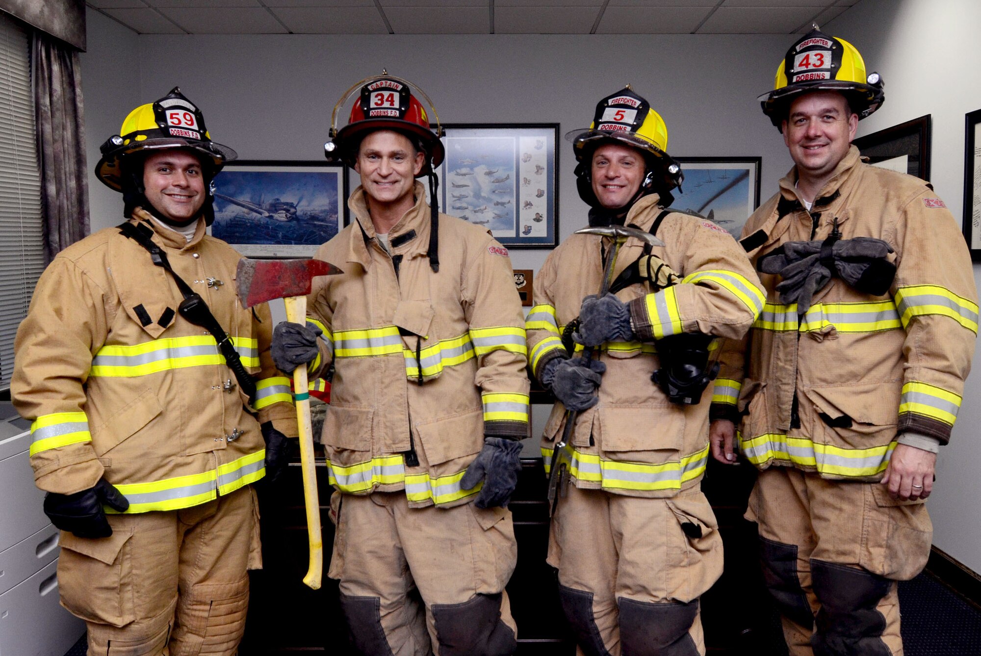 Col. Brett Clark, 94th Airlift Wing commander, poses for a photo with Dobbins firefighters for Dobbins Fire Prevention Week 2014, Oct. 3, 2014, at Dobbins Air Reserve Base, Ga. Fire Prevetion Week lasts from Oct. 6 through 10. (U.S. Air Force photo by Don Peek/Released)