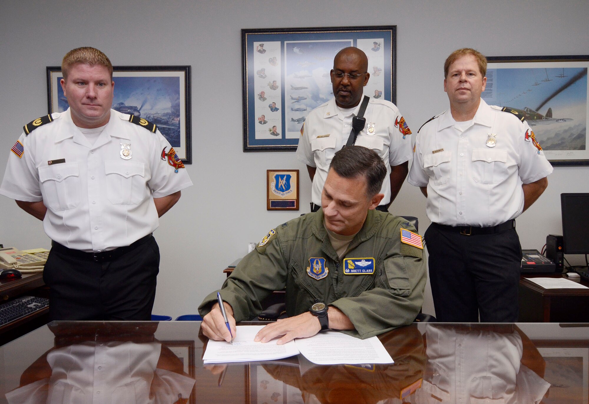Col. Brett Clark, 94th Airlift Wing commander, signs a proclamation for Dobbins Fire Prevention Week 2014, Oct. 3, 2014, at Dobbins Air Reserve Base, Ga. Fire Prevetion Week lasts from Oct. 6 through 10. (U.S. Air Force photo by Don Peek/Released)
