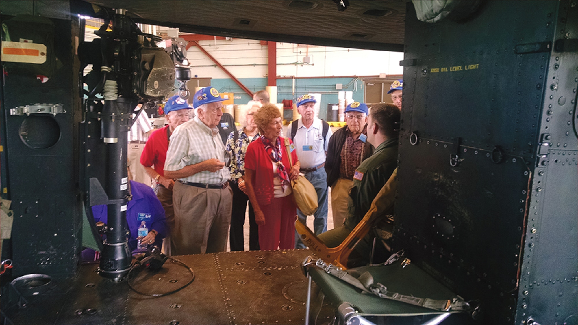 Members of the 339th Fighter Squadron Association get a briefing on a UH-1 helicopter during a tour of the 58th Special Operations Wing on Sept. 24. (Photo by Ryan Stark)