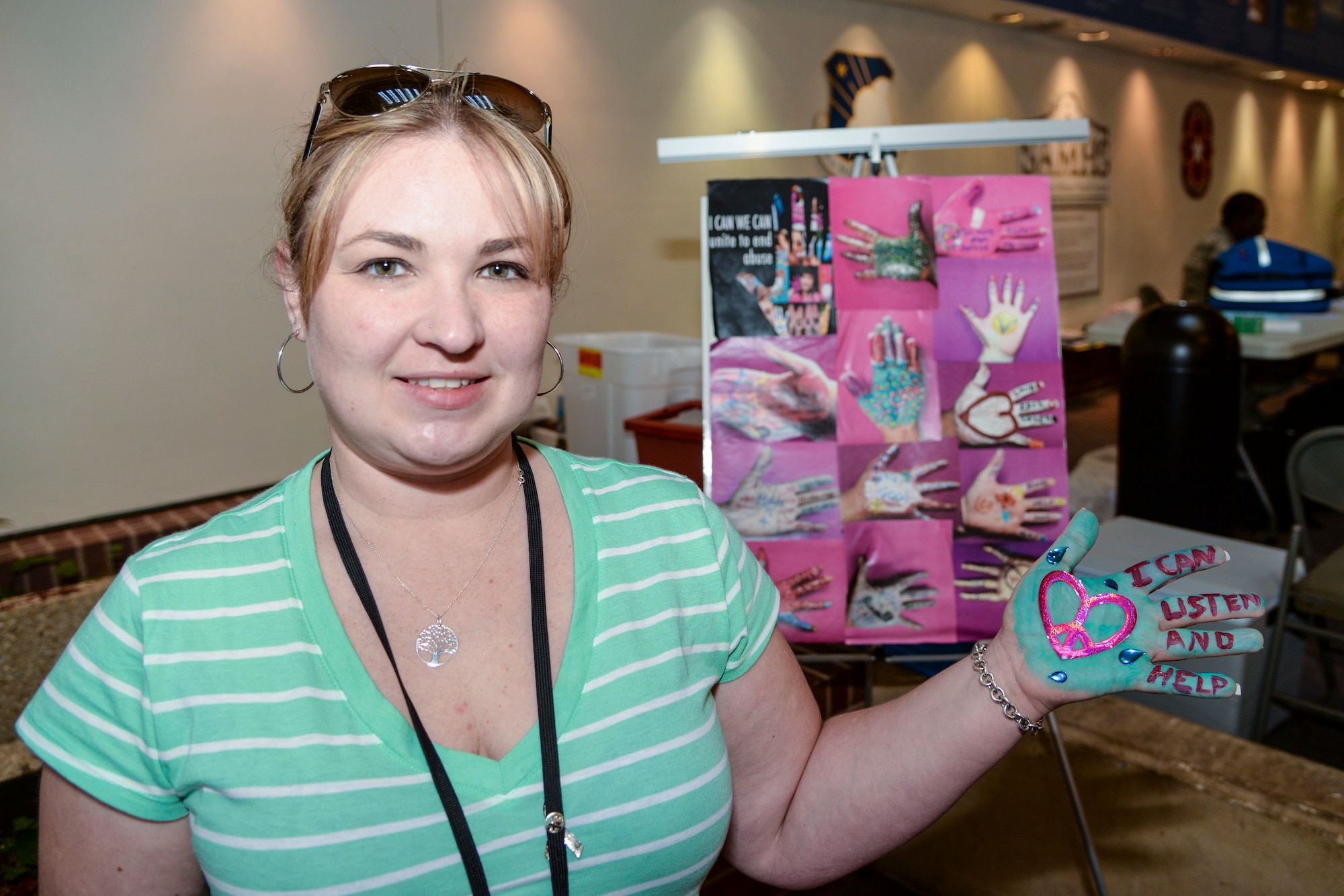 Dorie Budde, 59th Medical Wing Family Advocacy domestic abuse victim advocate, displays the pledges on her hand during the "I Can We Can" Domestic Violence Awareness Month event at the Wilford Hall Ambulatory Surgical Center, Joint Base San Antonio-Lackland, Texas, Oct. 3, 2014. Supporters painted and decorated their hand and wrote what they are going to do to help put an end to domestic violence. (U.S. Air Force photo/Senior Airman Michael Ellis)