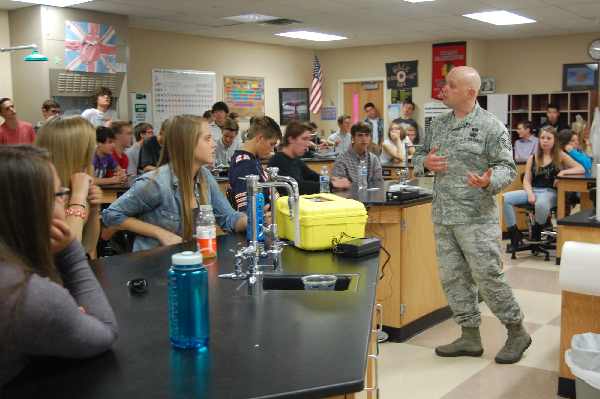 Master Sgt. Jared Hiles, emergency manager, 140th Wing, shares his expertise and equipment with high school students whose science teacher, Mr. Bart Blumberg, is also a Traditional Guardsmen and Staff Sergeant in the 140th Maintenance Squadron. Since the science department just learned about light and nuclear chemistry, Hiles brought in some chemical detection equipment that uses infrared spectroscopy and some radiation detectors to reinforce those lessons in Blumberg’s classes. (Air National Guard Photo by Capt. Kinder Blacke) 