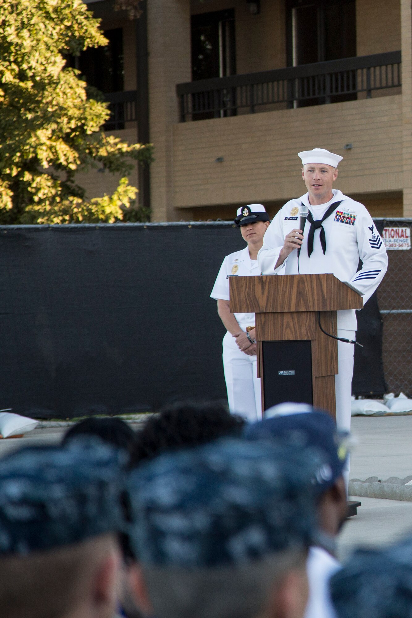 Master-at-Arms 1st Class Justin Treml speaks at a memorial dedication ceremony in honor of Master-at-Arms 2nd Class Mark Mayo Oct. 3, 2014 at the Naval Technical Training Center Lackland. Mayo died in the line of duty in March 2014 while stationed aboard the USS Mahan (DDG-72) at Norfolk Naval Station, Va. For his actions that day, Mayo was posthumously awarded the Navy Marine Corps Medal, the second-highest non-combat decoration awarded for heroism. (U.S. Air Force photo by Joshua Rodriguez/Released)