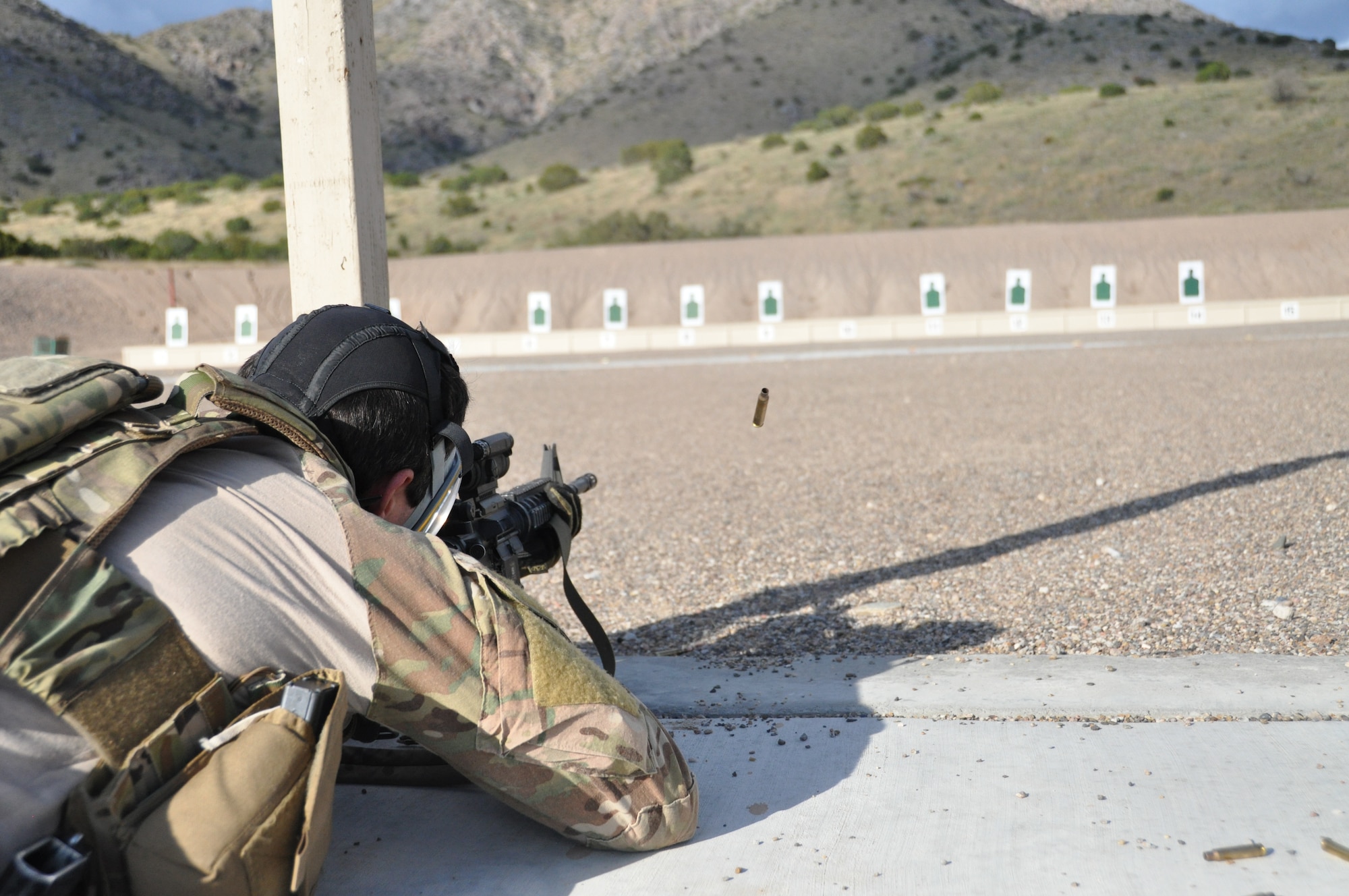 A pararescuman fires his rifle downrange as part of a shooting drill during the 2014 Guardian Angel Rodeo, Kirtland Air Force Base, New Mexico, September 24, 2014. The rodeo, or competition, was a week-long event that tested the PJs on land navigation skills, high-angel rope rescues, survival techniques, medical skills, weapons operations and overall physical endurance. (U.S. Air Force photo/ Tech. Sgt. Katie Spencer)  