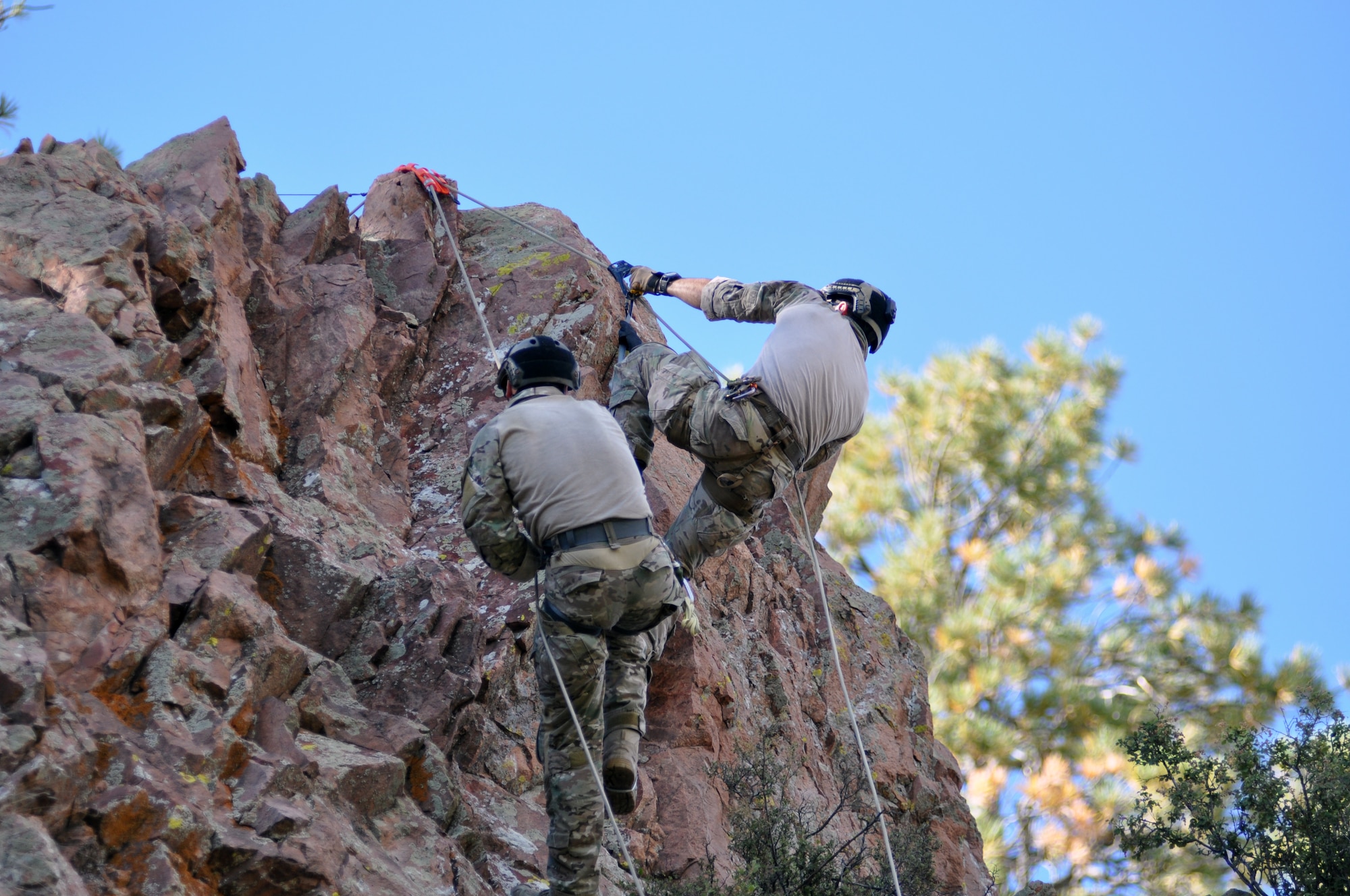Two pararescuemen ascend from an 80-foot vertical cliff during the 2014 Guardian Angel Rodeo, Grants, New Mexico, September 23, 2014. The rodeo, or competition, was a week-long event that tested the PJs on land navigation skills, high-angel rope rescues, survival techniques, medical skills, weapons operations and overall physical endurance. (U.S. Air Force photo/ Tech. Sgt. Katie Spencer)  
