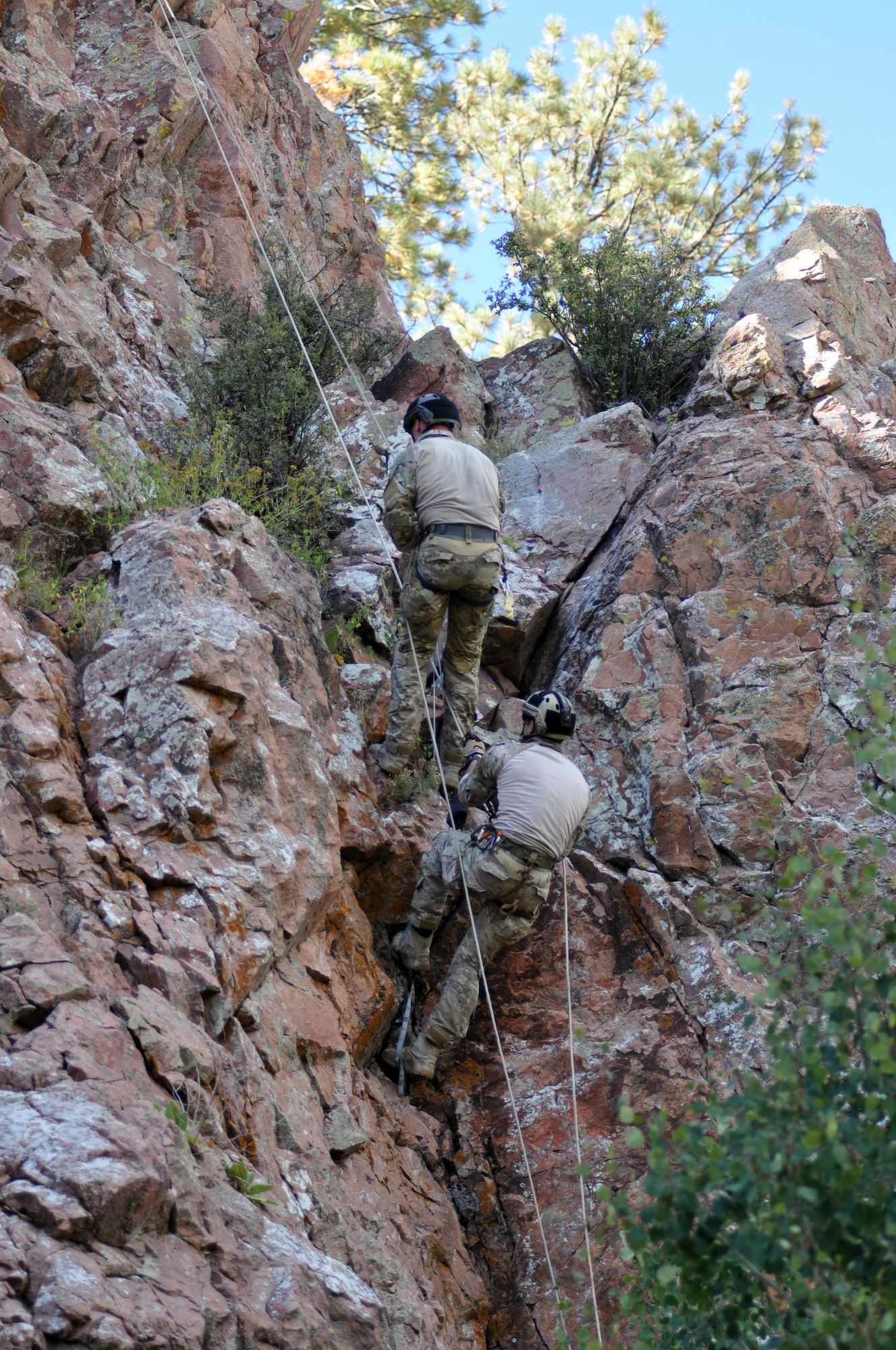 Two pararescuemen rappel down an 80-foot vertical cliff during the 2014 Guardian Angel Rodeo, Grants, New Mexico, September 23, 2014. The rodeo, or competition, was a week-long event that tested the PJs on land navigation skills, high-angel rope rescues, survival techniques, medical skills, weapons operations and overall physical endurance. (U.S. Air Force photo/ Tech. Sgt. Katie Spencer)  