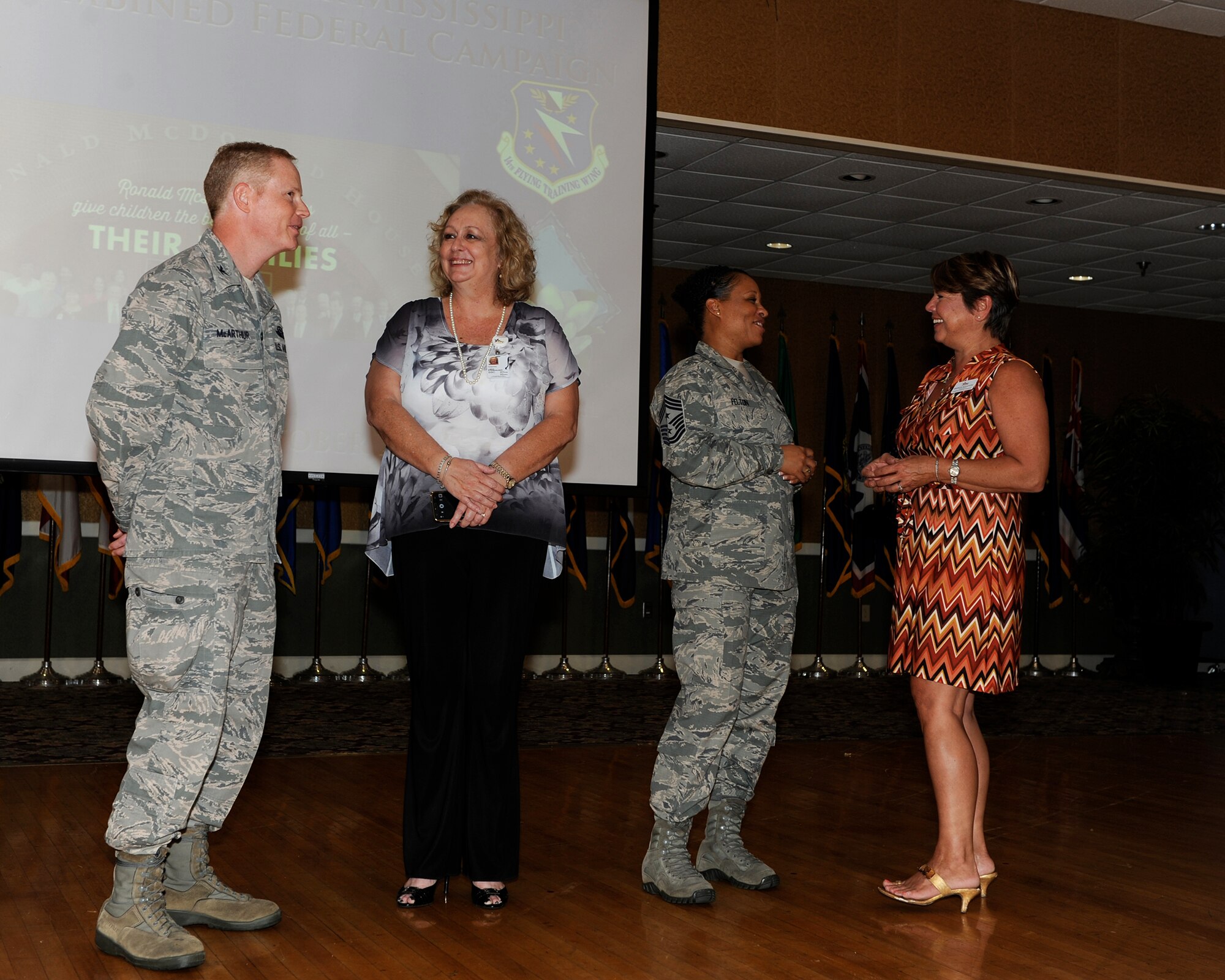 Col. Howard McArthur, 14th Flying Training Wing Vice Commander, speaks with Linda Steinhauser, Greater Mississippi Combined Federal Campaign Director, while Chief Master Sgt. Rita Felton, 14th FTW Command Chief, speaks with Mignon Bouchon, Greater Mississippi Combined Federal Campaign Deputy Director, during the CFC luncheon Sept. 30 at the Columbus Club. The mission of the CFC is to promote and support philanthropy through a program that is employee-focused, cost-efficient, and effective in providing all federal employees the opportunity to improve the quality of life for all. (U.S. Air Force photo/Elizabeth Owens)