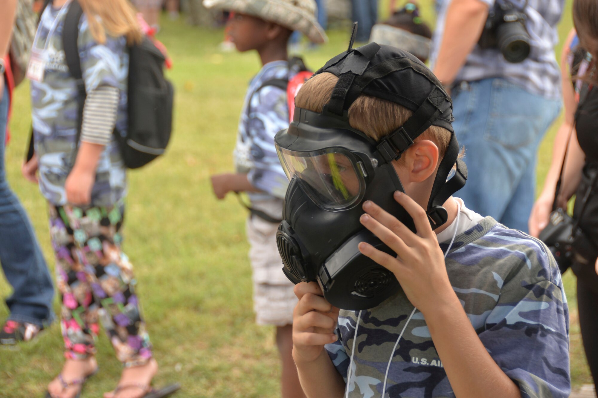 An Operation Hero participant, son of Tech. Sgt. Chad Sawel, 26th Operational Weather Squadron tries on a gas mask on Barksdale Air Force Base, La., Sept. 27, 2014. 2nd CES Airmen demonstrated hazardous material detection and gas mask operation. (U.S. Air Force photo/Airman 1st Class Mozer O. Da Cunha)
