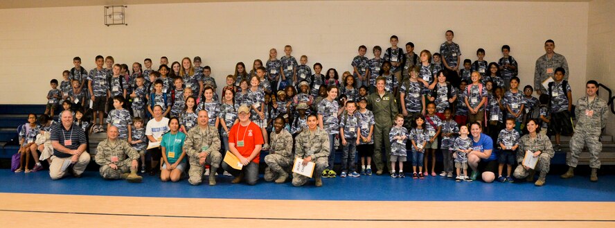 Col. Kristin Goodwin, 2nd Bomb Wing commander, poses for a group photo with Operation Hero participants on Barksdale Air Force Base, La., Sept. 27, 2014. Operation Hero is a mock deployment intended to give children a better understanding of the deployment process their parents go through. (U.S. Air Force photo/Airman 1st Class Mozer O. Da Cunha)
