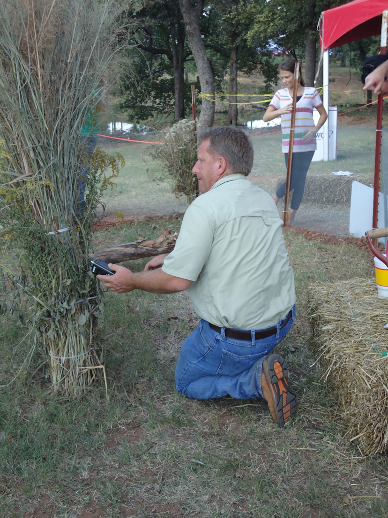 Raymond Moody, a Natural Resources biologist with the 72nd Civil Engineering Directorate, uses a tracking device to try to locate one of the Texas Horned Lizards on display in Tinker’s booth at the Oklahoma Wilderness Expo last weekend at the Lazy E Arena. One of the lizards went missing for a short time, but Mr. Moody found him and all the lizards are back safe and sound at their habitat here on Tinker. (Air Force photos by Kimberly Woodruff)

