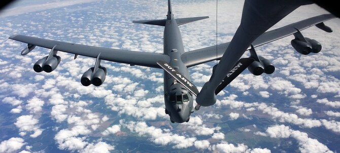 A KC-135R Stratotanker flown by a 465th Air Refueling Squadron crew from Tinker Air Force Base refuels a B-52 Stratofortress over the skies of Texas, Aug. 17. The B-52 crew flew out of Barksdale AFB and conducted several aerial refueling evaluations during the training exercise. (Air Force photo by Maj. Jon Quinlan)