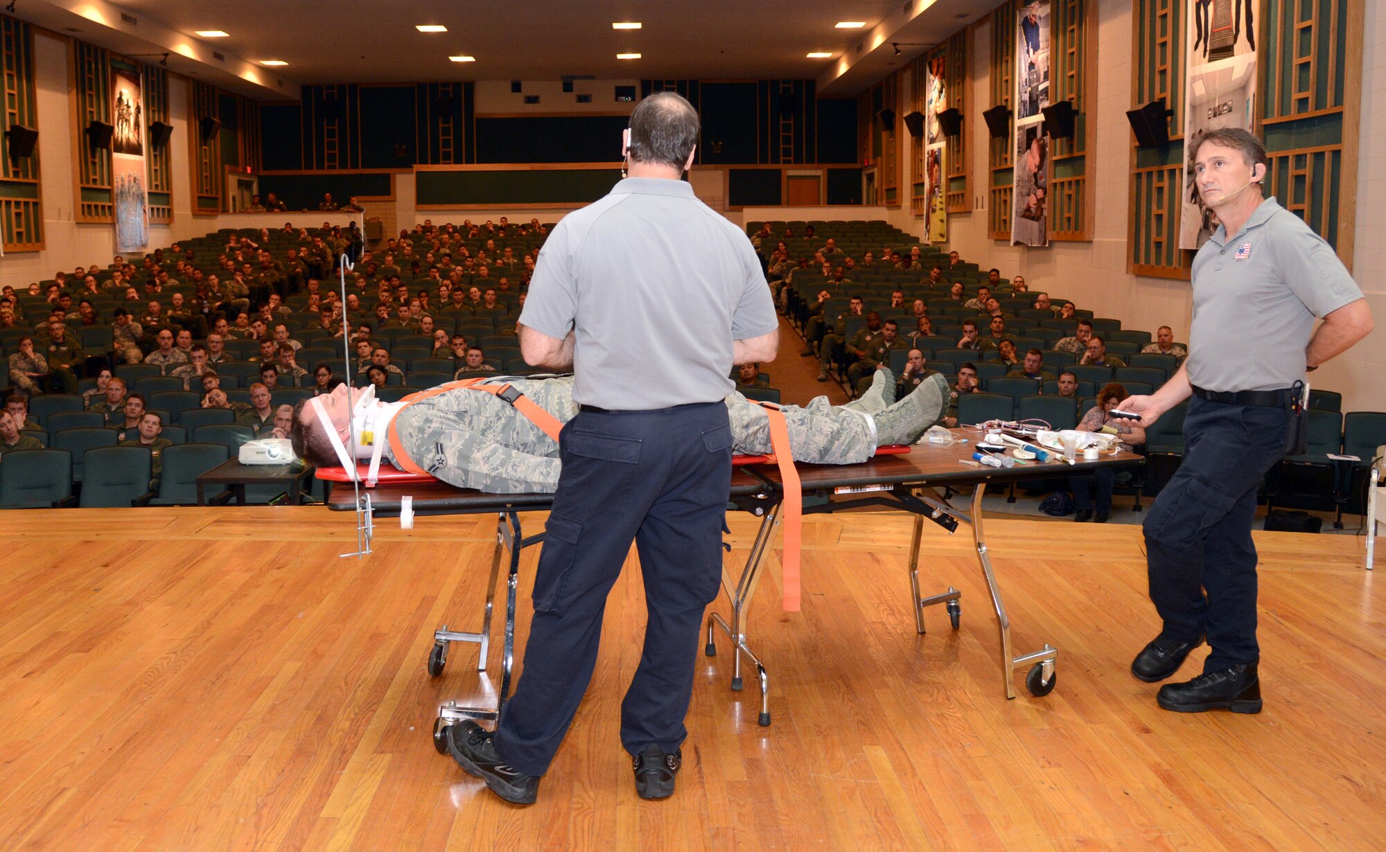 Lieutenants Ralph Jimenez and Vince Easevoli, firefighter-paramedics from Miami and founder and co-founder of Staying Alive From Education (S.A.F.E.) use Airman 1st Class Matt Davis, 965th Airborne Air Control Squadron, as an example of how they perform emergency rescue services on a trauma patient from a vehicle crash and describe what will happen in the hours following that crash. (Air Force photo by Kelly White)