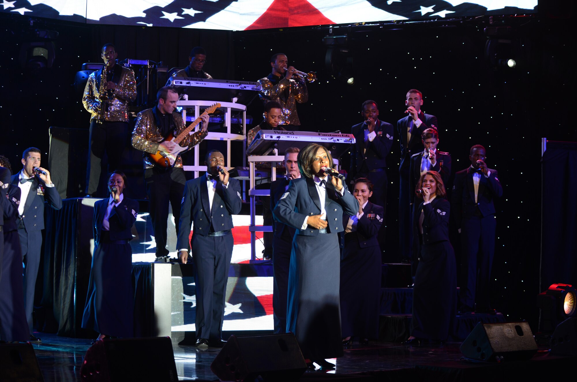 Tops in Blue members perform at the Northside Fitness Center Oct. 1, 2014, on RAF Mildenhall, England. Following the pop songs sung in the beginning of the show, the performers ended with patriotic anthems dressing in mess dress attire. (U.S. Air Force photo/Airman 1st Class Dillon Johnston/Released)
