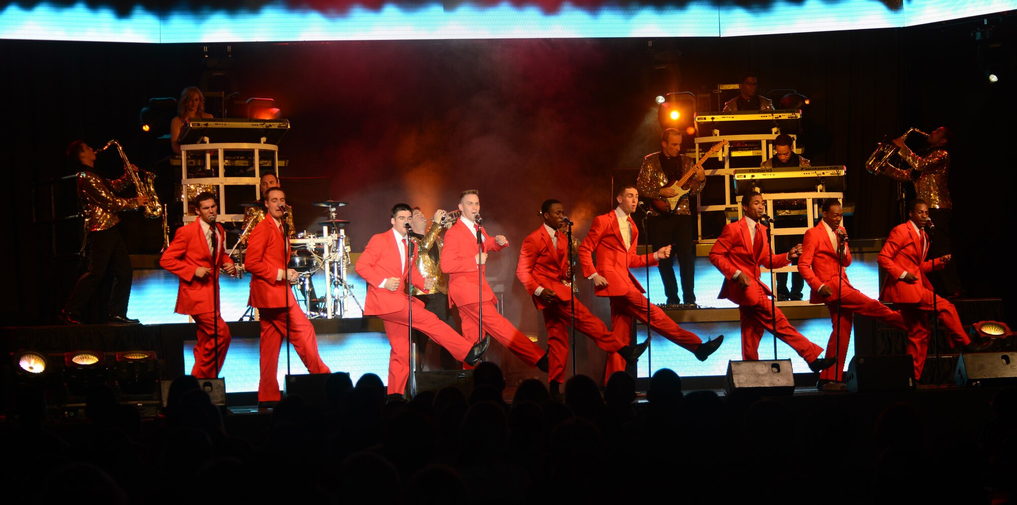 Tops in Blue members perform at the Northside Fitness Center Oct. 1, 2014, on RAF Mildenhall, England. Throughout the show, the performers wore a multitude of costumes to match the era and genre of music they sang. (U.S. Air Force photo/Airman 1st Class Dillon Johnston/Released)