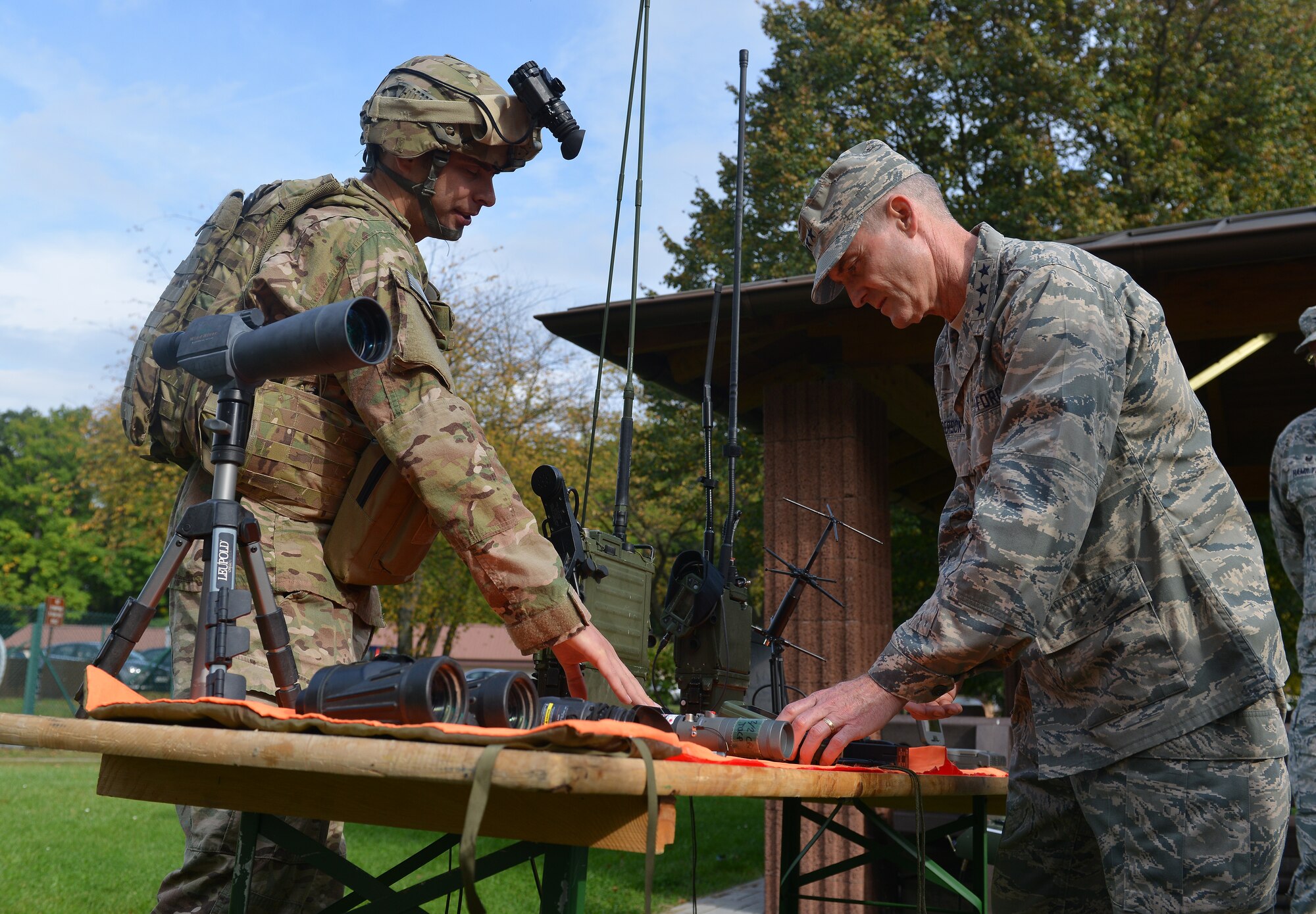 Tech. Sgt. Cole Waterbury, 2nd Air Support Operations Squadron joint terminal attack controller, explains the importance of his equipment to Lt. Gen. Darryl Roberson, 3rd Air Force and 17th Expeditionary Air Force commander, during an immersion tour on Kapaun Air Station, Germany, Sept. 30, 2014. Roberson met multiple Airmen while learning their day-to-day tasks during his tour of multiple units within the wing. The tour helped give him a better understanding of the wing’s operations and how it contributes to the overall Air Force mission. (U.S. Air Force photo/Senior Airman Holly Mansfield)