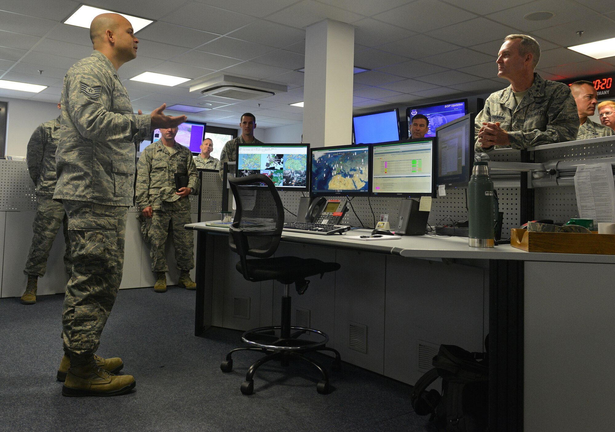 Tech. Sgt. Anthony Fountain, 21st Operational Weather Squadron visual weather system administrator, briefs Lt. Gen. Darryl Roberson, 3rd Air Force and 17th Expeditionary Air Force commander, about the day-to-day tasks of the weather forecasting operations floor during an immersion tour on Kapaun Air Station, Germany, Sept. 30, 2014. Roberson met with Airmen from the 435th Air Ground Operations Wing while learning about their day-to-day tasks during his tour of multiple units within the wing. The tour helped give him a better understanding of the wing’s operations and how it contributes to the overall Air Force mission.  (U.S. Air Force photo/Senior Airman Holly Mansfield)