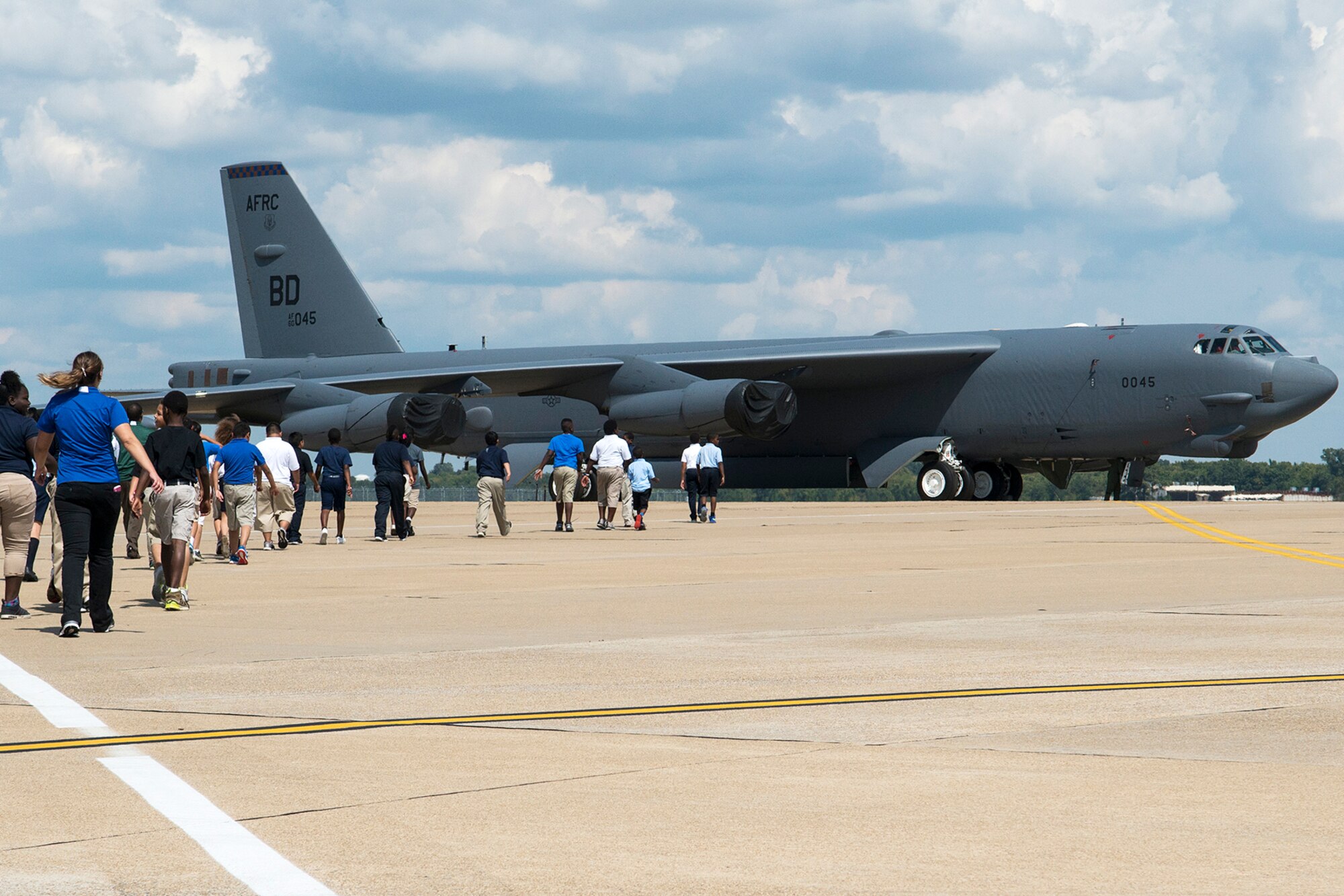 A group of STARBASE students walk across the flight line to get a tour of a 93rd Bomb Squadron B-52H Stratofortress, Sept. 30, 2014, Barksdale Air Force Base, La. The STARBASE program is a 25-hour hands on/minds on environment that actively engages students in exploration of Science, Technology, Engineering and Mathematics to excite their interest, develop a solid concept base and encourage pursuit of these four fields for future careers. (U.S. Air Force photo by Master Sgt. Greg Steele/Released)