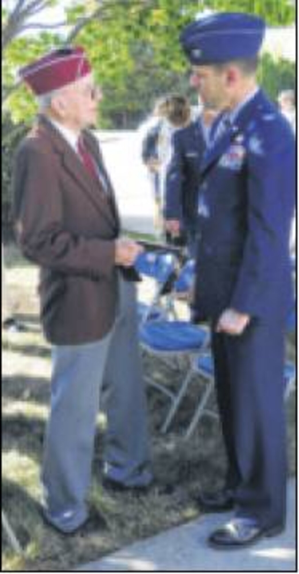 Col. John Devillier, commander of the 88th Air Base Wing, talks with Andrew Stanley, World War ll master sargeant, B-17 tail gunner,and prisoner of war, and veteran of Korea and Vietnam wars, before the base's observance of National POW/MIA Recognition Day on Sept. 26 outside the Arnold House. (Skywrighter photo by James Tyler)