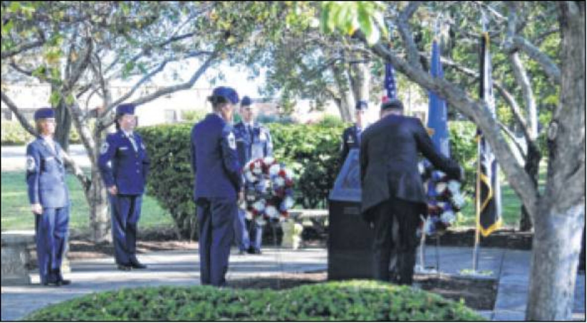 Chief Master Sft. lleathear Maxwell, Wright-Patterson AFB Chiefs Group president, and Stephen Goeman, retired colonel and former commander of the 445th Airlift Wing, C-17 Training site manager and vice president of the Miami Valley Military Affairs Association, place wreaths in front of the base's POW/MIA Memorial Sept 26. (Skywrighter photo by James Tyler)