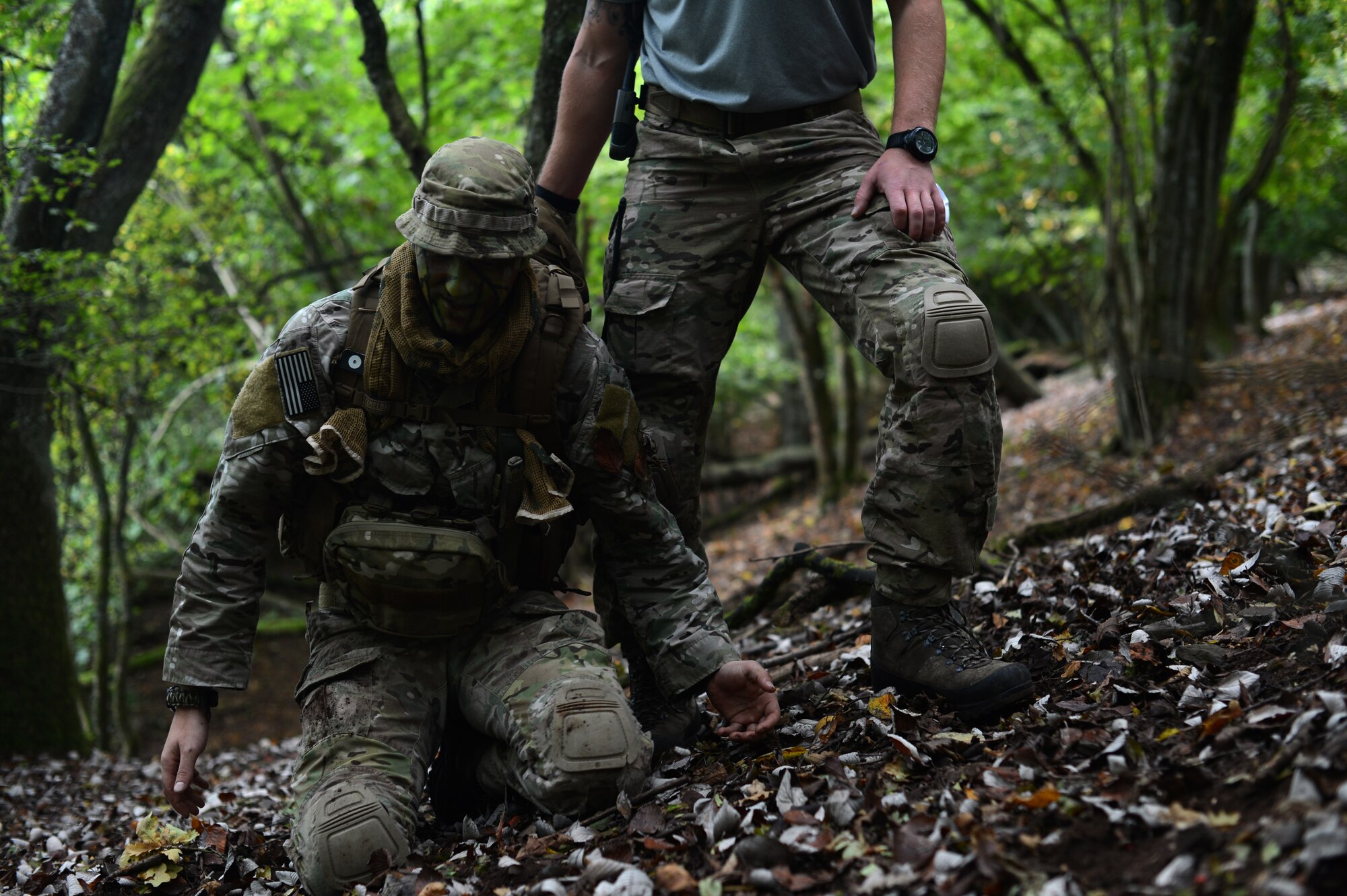 U.S. Air Force Staff Sgt. Justin Gordon, 52nd Operations Support Squadron survival, evasion, resistance and escape NCO in charge of operations, right, captures U.S. Air Force Tech. Sgt. John Long, 52nd Operations Support Squadron SERE NCO in charge of weapons and tactics, during combat survival training on a range in Baumholder, Germany, Sept. 30, 2014. SERE specialists enabled pilots to experience Code of Conduct continuation training to give them the necessary skills to return home after being captured. (U.S. Air Force photo by Senior Airman Gustavo Castillo/Released) 