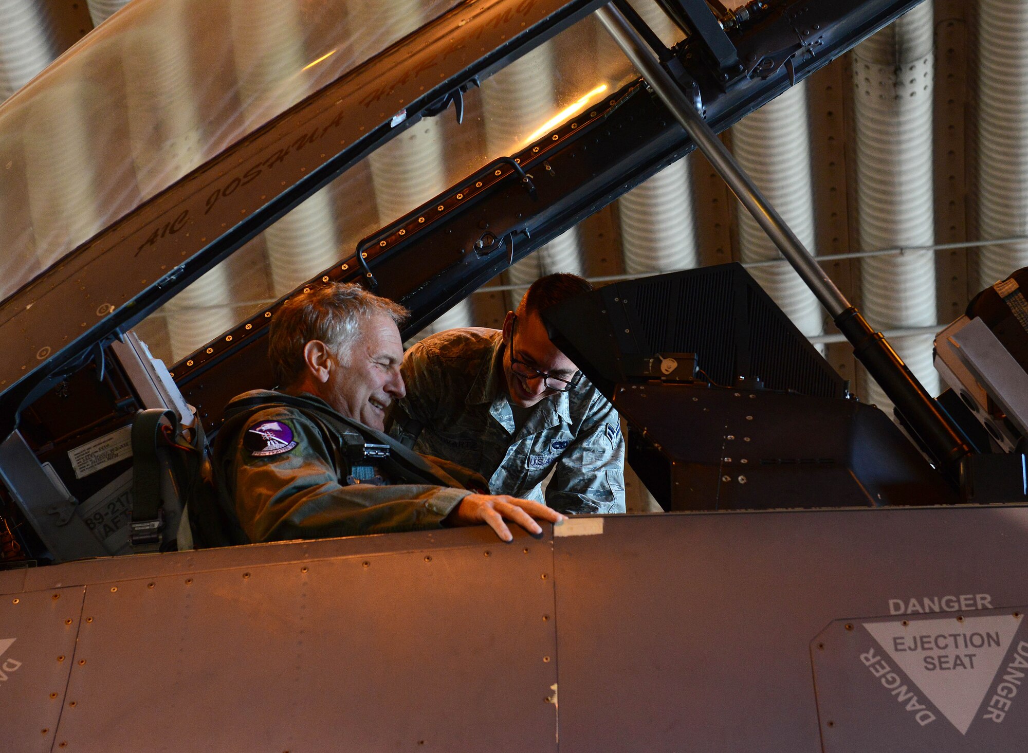 Airman 1st Class Michael Schwartz, 31st Aircraft Maintenance Squadron dedicated crew chief, secures John Phillips, U.S. Ambassador to Italy, into his F-16 Fighting Falcon seat during a visit, Oct. 2, 2014, at Aviano Air Base, Italy. Phillips was joined by Philip Reeker, U.S. Consul General, who both visited Aviano to familiarize themselves with the 31st Fighter Wing mission.  (U.S. Air Force photo/Senior Airman Michael Battles)