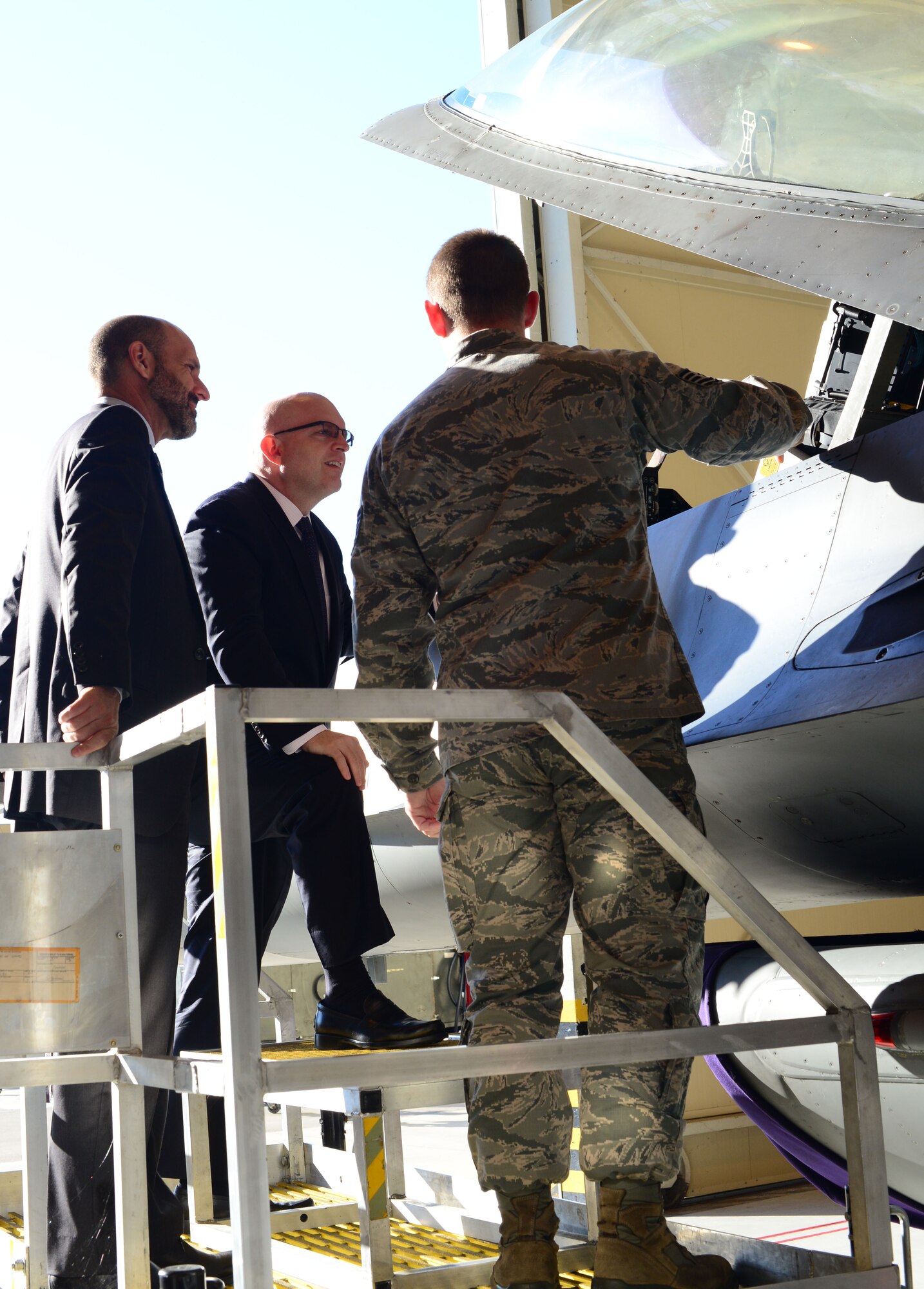 Tech. Sgt. Michael Botti (right), 31st Maintenance Squadron inspection section dock chief, briefs Philip Reeker (center), U.S. Consul General, on the capabilities of the F-16 Fighting Falcon, Oct. 2, 2014, at Aviano Air Base, Italy. Reeker heads the U.S. Consulate General Milan, which serves northern Italy. (U.S. Air Force photo/Senior Airman Michael Battles)