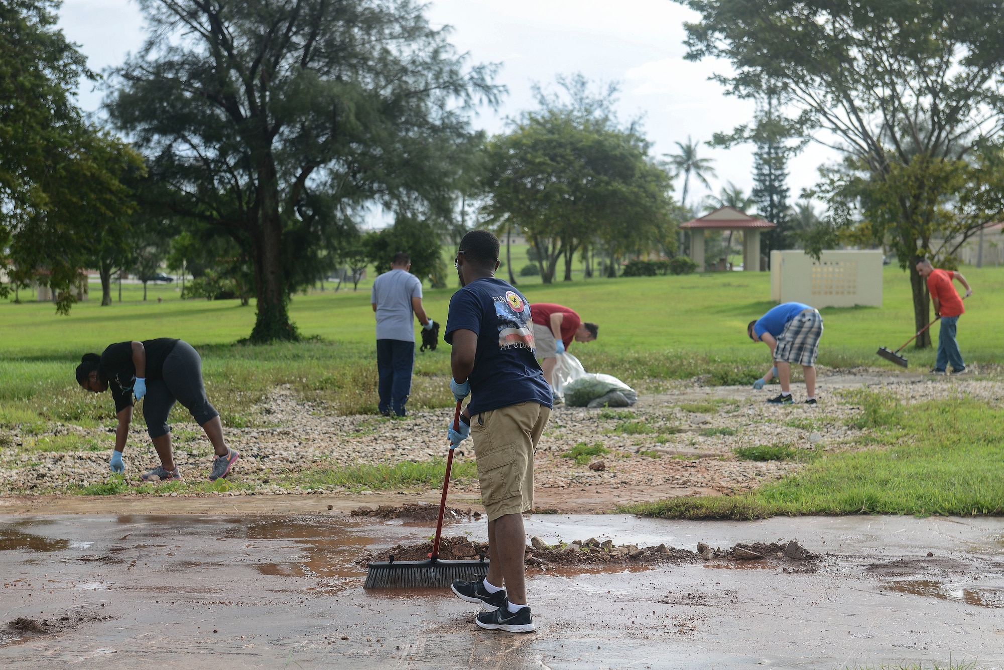 Members of Team Andersen pick up debris and clear pathways Arc Light memorial Oct. 1, 2014, on Andersen Air Force Base, Guam. Airmen picked up trash at the ARC LIGHT Memorial and F-4E Phantom II site to preserve Andersen’s history.  (U.S. Air Force photo by Airman 1st Class Adarius Petty/Released)