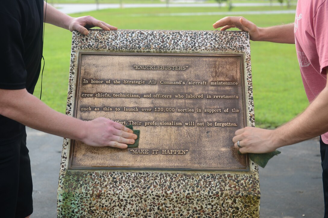 Airmen scrub brass pillars at the Arc Light memorial Oct. 1, 2014, on Andersen Air Force Base, Guam. Airmen picked up trash at the Arc Light memorial and F-4E Phantom II site, to preserve Andersen’s history.  (U.S. Air Force photo by Airman 1st Class Adarius Petty/Released)