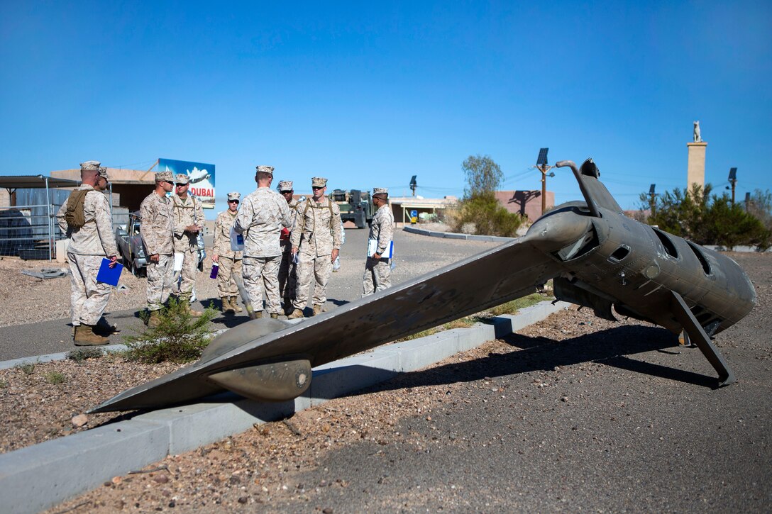 Marines receive a brief before an aircraft salvage exercise at K-9 village on Yuma Proving Grounds, Ariz., Sept. 24, 2014. The Marines are aircraft rescue and firefighting specialists assigned to Marine Wing Support Squadron 372, Marine Aircraft Group 39, 3rd Marine Aircraft Wing. The exercise is part of Weapons and Tactics Instructor 1-15, a seven-week event hosted by the Marine Aviation Weapons and Tactics Squadron One cadre.