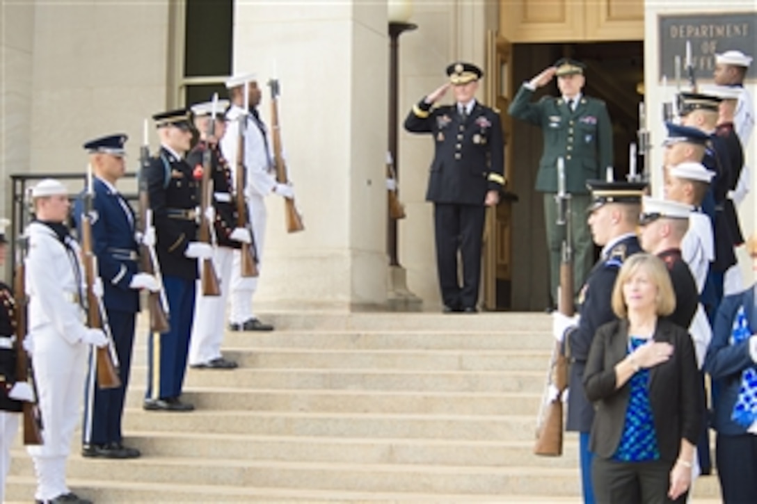 U.S. Army Gen. Martin E. Dempsey, left, chairman of the Joint Chiefs of Staff, and Danish Army Gen. Knud Bartels, left, chairman of NATO's Military Committee, salute during an honor cordon at the Pentagon, Oct. 2, 2014. 