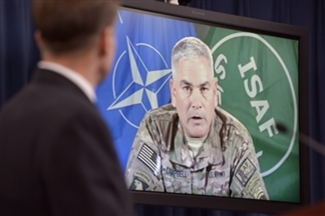Pentagon Press Secretary Navy Rear Adm. John Kirby moderates a press conference with Army Gen. John F. Campbell, commander of U.S. and international forces in Afghanistan, during a remote broadcast session with reporters at the Pentagon, Oct. 2, 2014. 