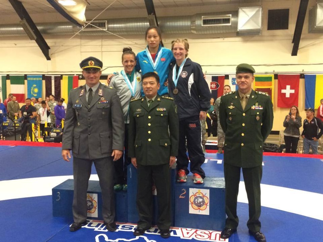 Army Sgt. Whitney Condor takes silver in the Women's 53kg Freestyle Division during the 2014 CISM World Military Wrestling Championship at Joint Base McGuire-Dix-Lakehurst, New Jersey on 3 October 2014.

Gold - Hui Li (China); Silver- Whitney Conder (USA); Bronze- Jaqueline Schellin (Germany)
